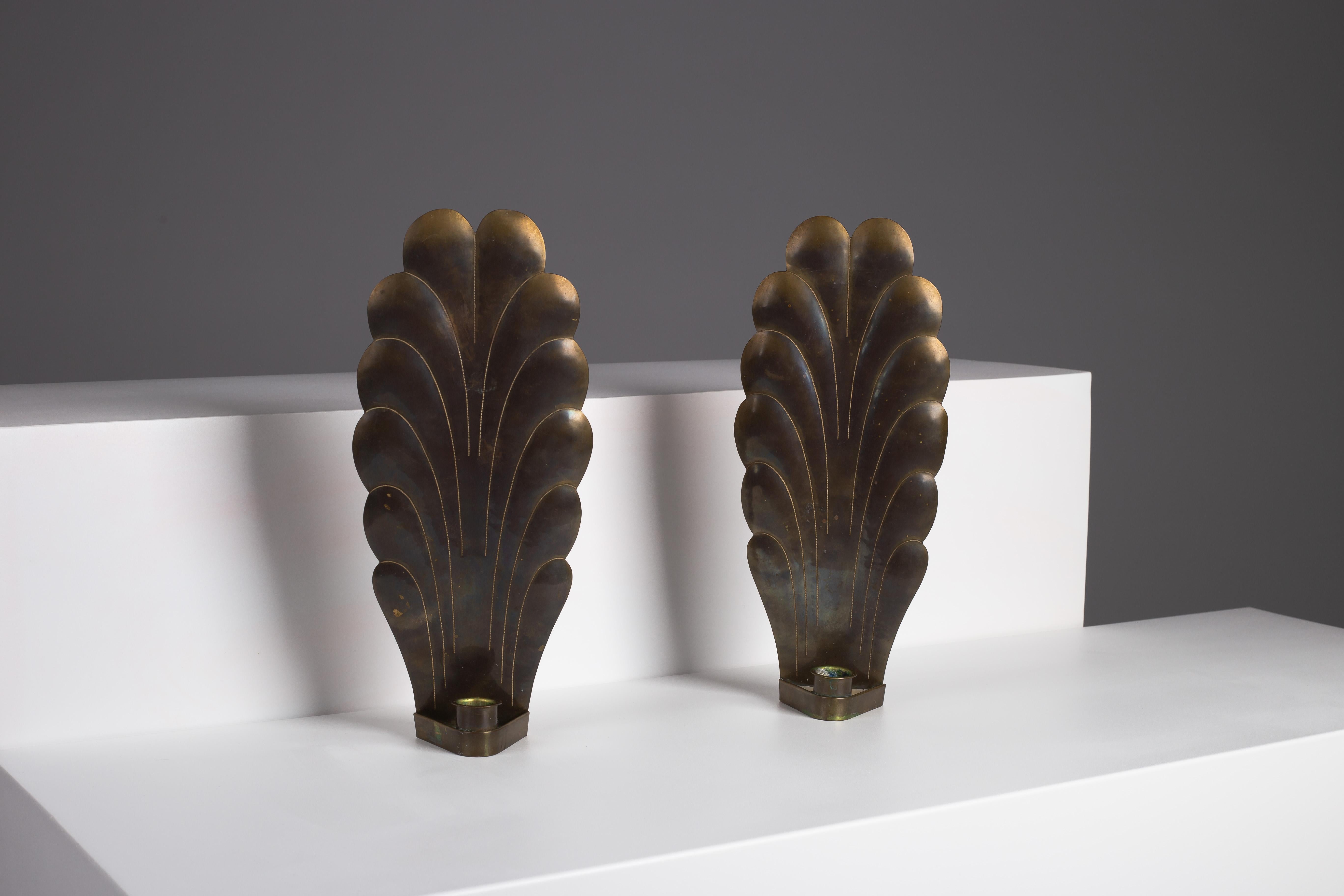 Immerse your home in timeless elegance with this pair of Swedish art deco wall sconces, each showcasing a rich, beautiful patina. Expertly crafted on the picturesque island of Öland, Sweden, these pieces reflect the impeccable craftsmanship and