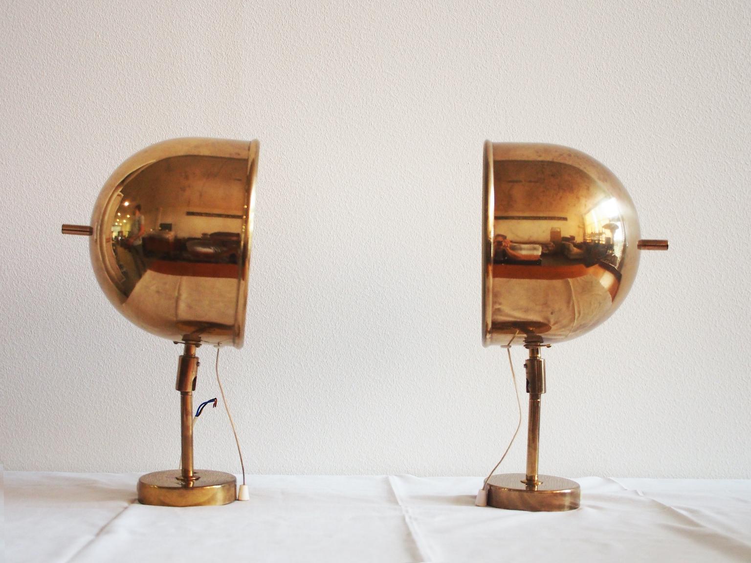 Pair of brass adjustable wall lamps made by Bergboms in Sweden, circa 1970. Brass exterior with slight patina, interior painted white. Cord to pull to switch the lamps on and off.