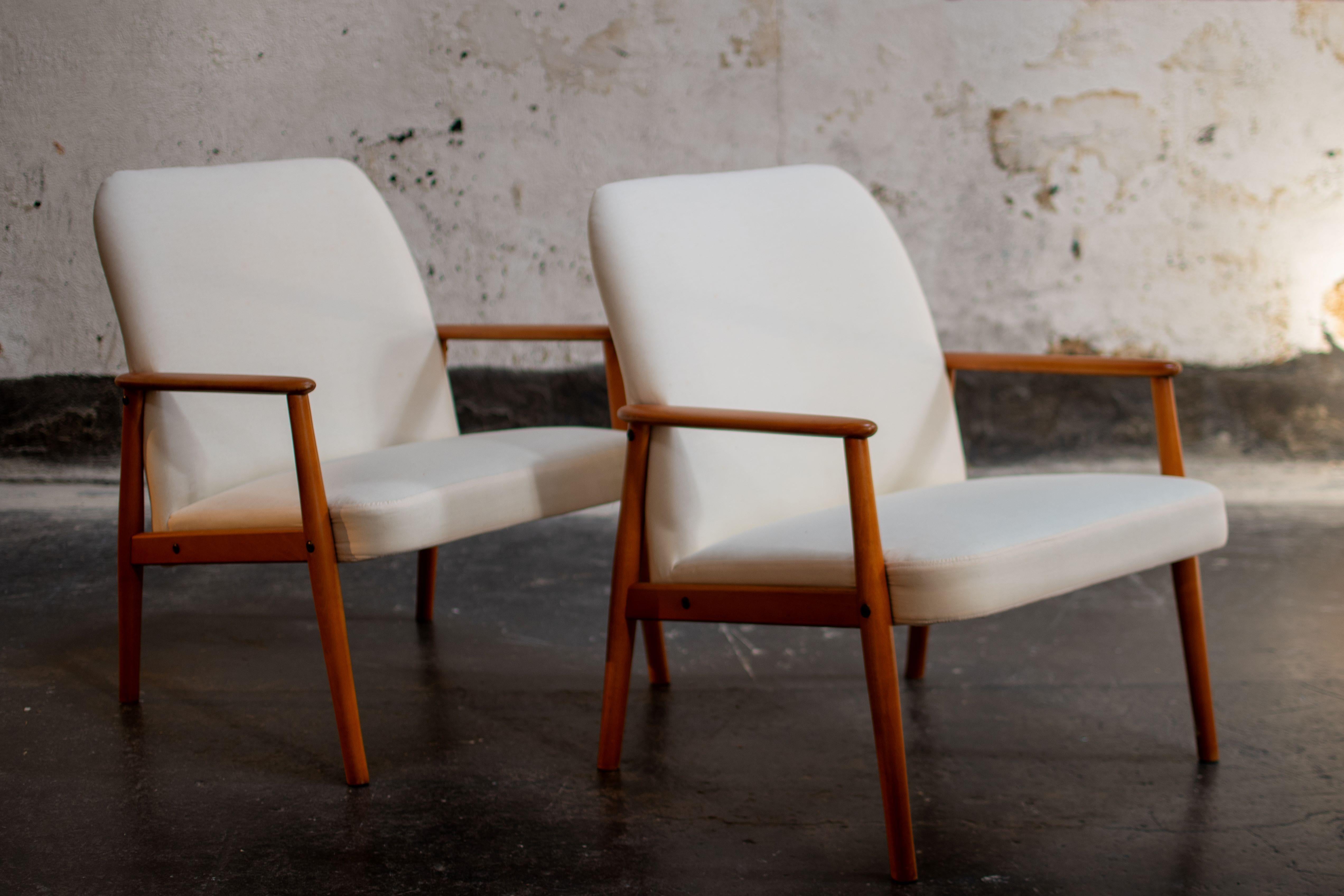 Pair of Swedish Scandinavian Modern lounge chairs - newly restored and reupholstered. Clean lines, warm wood,  and tapered legs embody the image of Scandinavian modern style. Scandinavian interiors often have very low ceilings to contain heat,