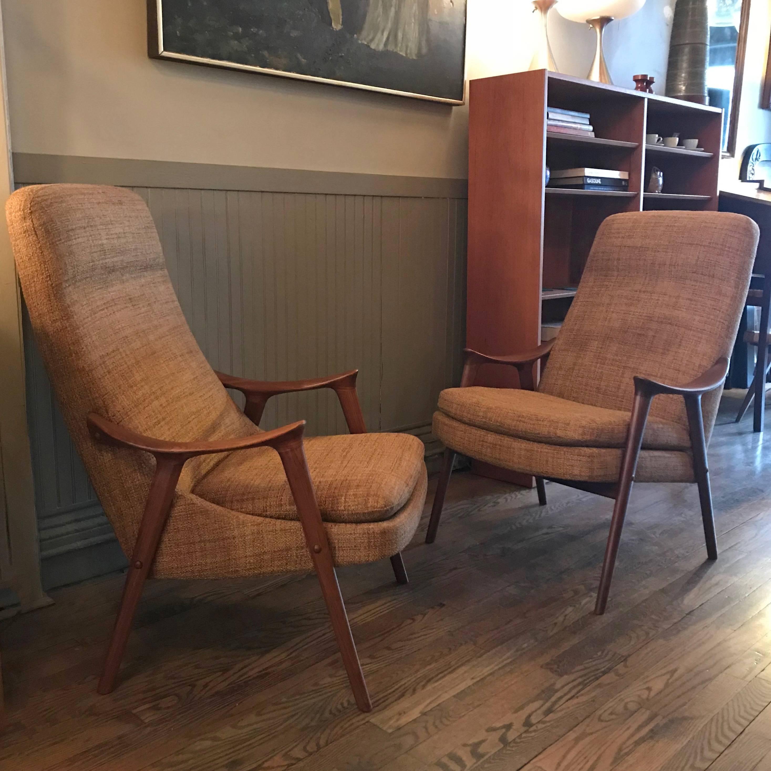 Pair of Scandinavian modern, high back, His and Hers lounge chairs designed by Ingmar Relling for Gustav Bahus and distributed by Westnofa, Norway. The chairs differ slightly and feature newly finished walnut frames with scoop arms and new