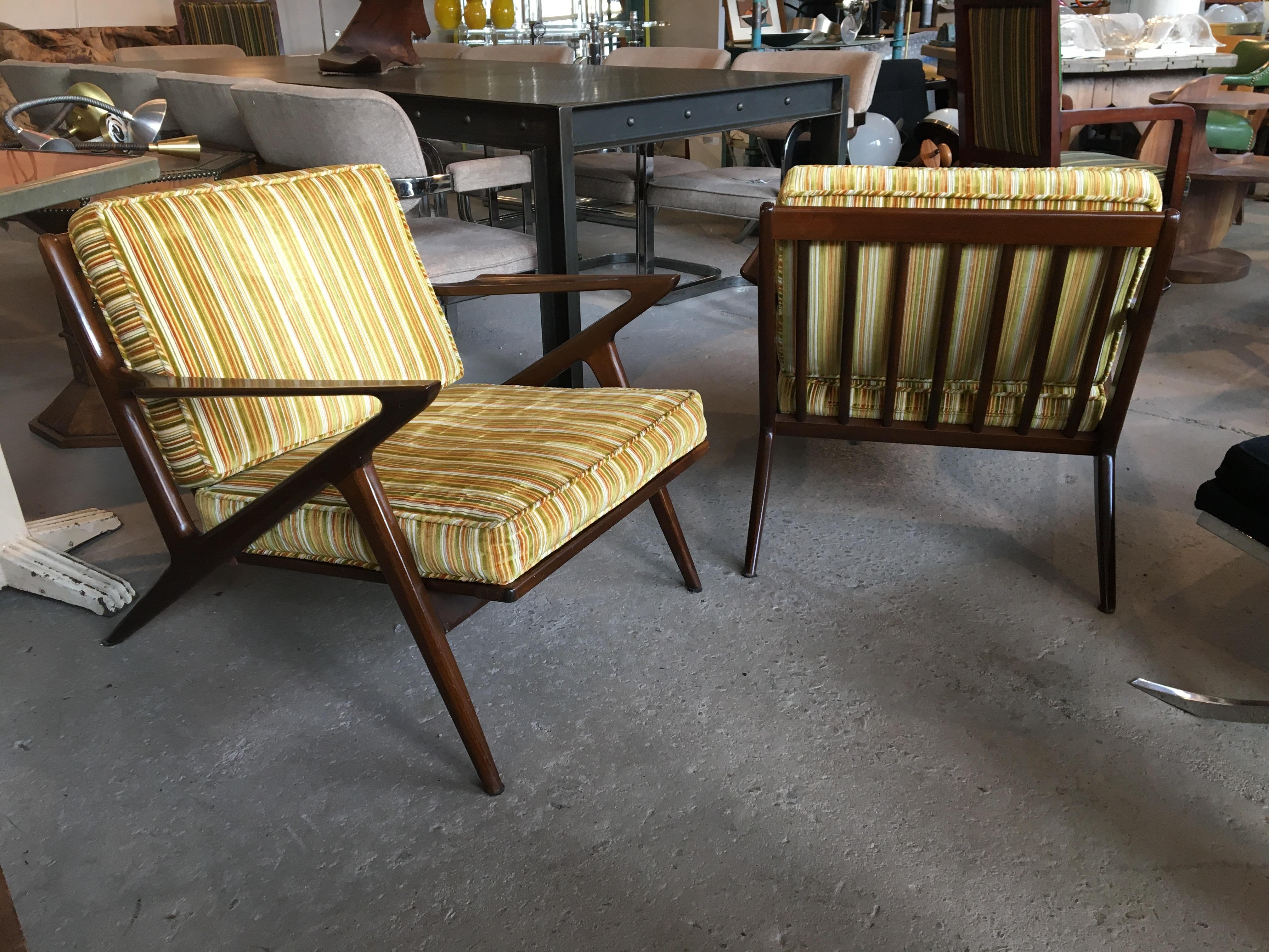 Pair of original walnut Z chairs, designed by Poul Jensen for Selig, circa 1960s. Both chairs retain their original Selig made in Denmark metal mark. Wood has great rich color, and webbing in very good condition. Cushions in vintage striped