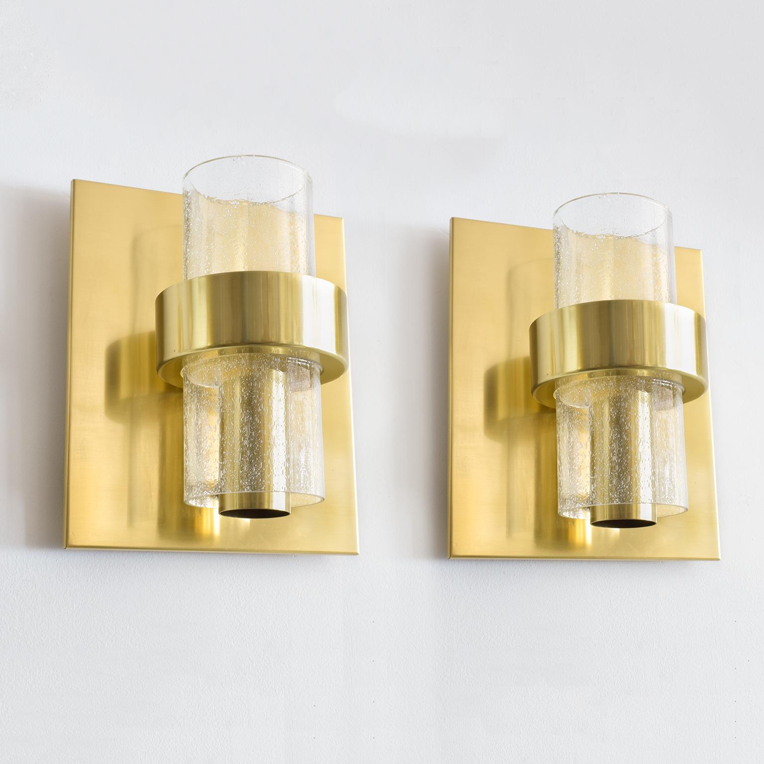 Pair of polished and lacquered brass sconces with hand-forged glass shades which contain decorative air bubbles. Each sconce has been rewired with one standard base socket for use in the USA. Designed by Jonas Hidle, for Hovik Verk, Lys, Norway,