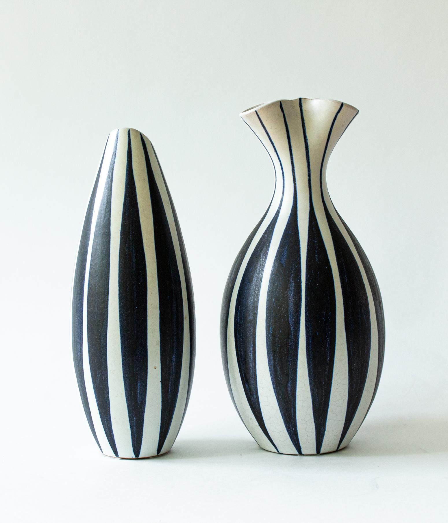 A pair of Scandinavian Modern vases with stripes in dark blue and white. Made by Mette Doller and Ivar Eriksson for Hoganas, Höganäs.