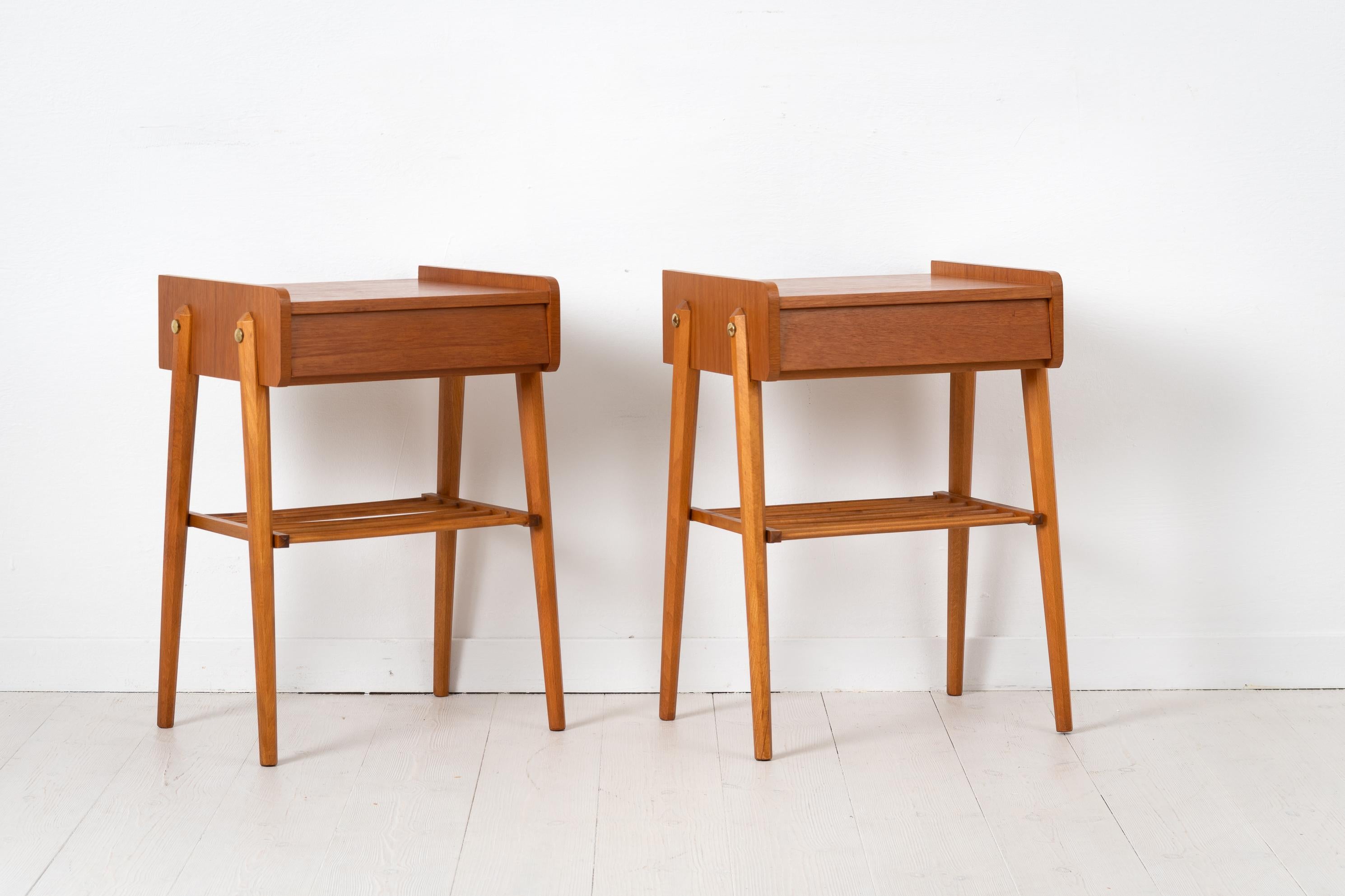 Scandinavian modern teak nightstands from the mid 20th century. The pair are designed and made in Sweden and have a single large drawer as well as a ribbed shelf. A decorative detail is the brass hardware. Marked AB BJÄRNI Bjärnum which is a Swedish