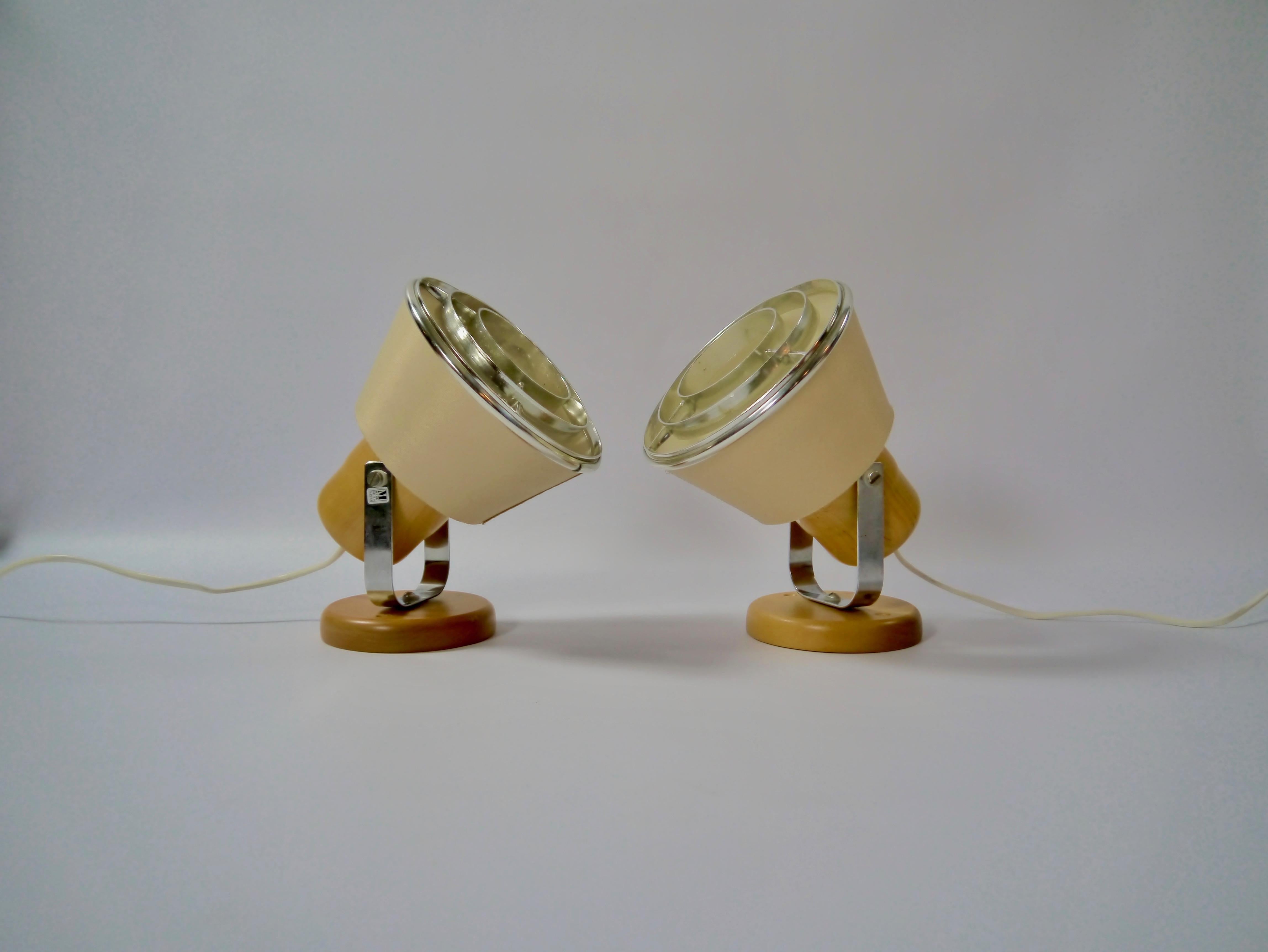 Pair of wall mount bedside lamps fabricated by Markslöjd in the 1970s. The beige fabric lampshade gives a soft and warm light.