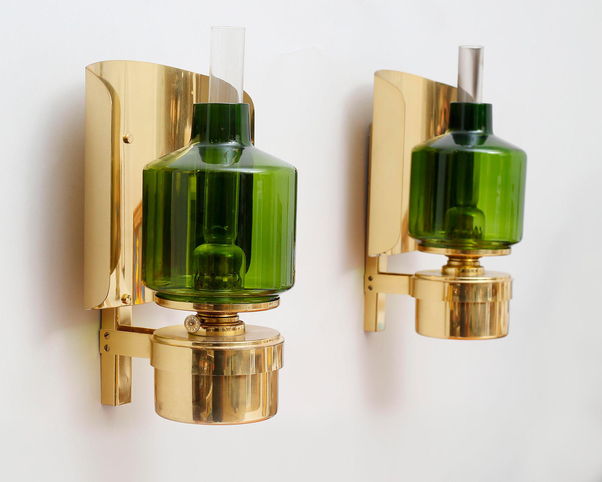Pair of Scandinavian Modern Wall-scones, L137, by Hans Agne Jakobsson, Markaryd.
Very rare kerosene lamps. wall mounted with brass frame, green tinted glass cover, labeled Hans-Agne Jakobsson Markaryd L 137. Mint condition. Make a statement off