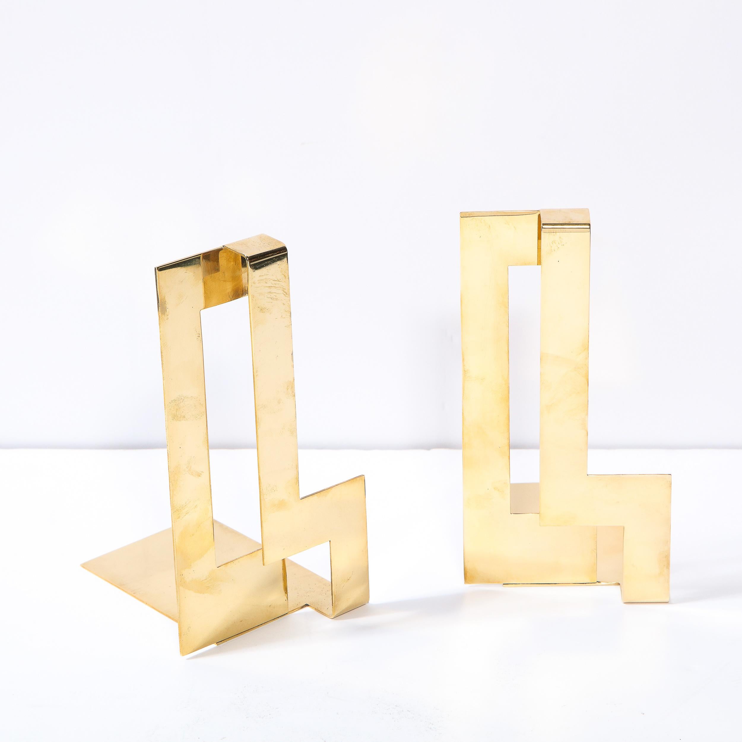 This stunning pair of Scandinavian modernist bookends were realized by the esteemed Swedish maker Skultana during the latter half of the 20th century. They offer dynamic rectilinear forms in lustrous polished brass. With their hardedge geometry and