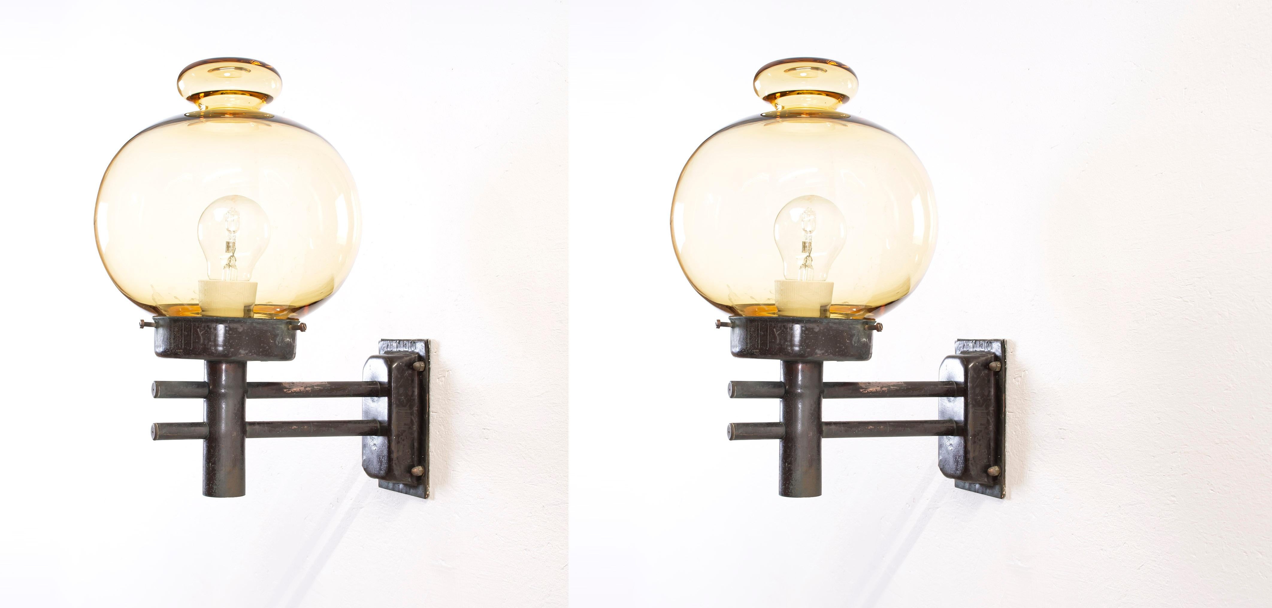 Modernist pair of outdoor wall lamps in copper and glass. Designed and made in Norway from circa 1970s first half. Both lamps are fully working and in very good vintage condition. The lamps are fitted with one E27 bulb holder (works in the US), and
