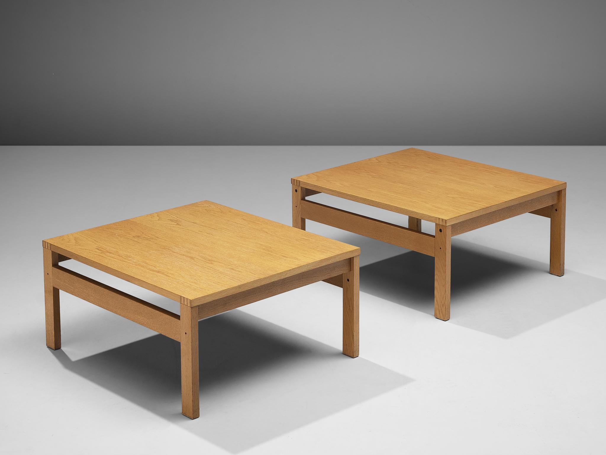 Pair of side tables, oak, Scandinavia, 1960s 

The design of this pair of side tables shows a strong and solid construction executed in oak. This is realized by the sharp and clear lines which are visible at the edges of the top and on the long