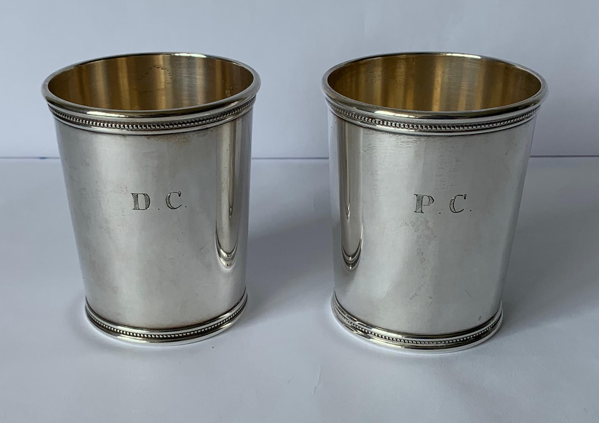 Pair of Mark Scearce LBJ 1960s sterling silver julep cups. Stamped on the underside. Gold washed interior. Each cup is engraved with monogramed D.C. and P.C. Each cup comes with flannel storage bag. Total weight is 9.59 Troy oz.