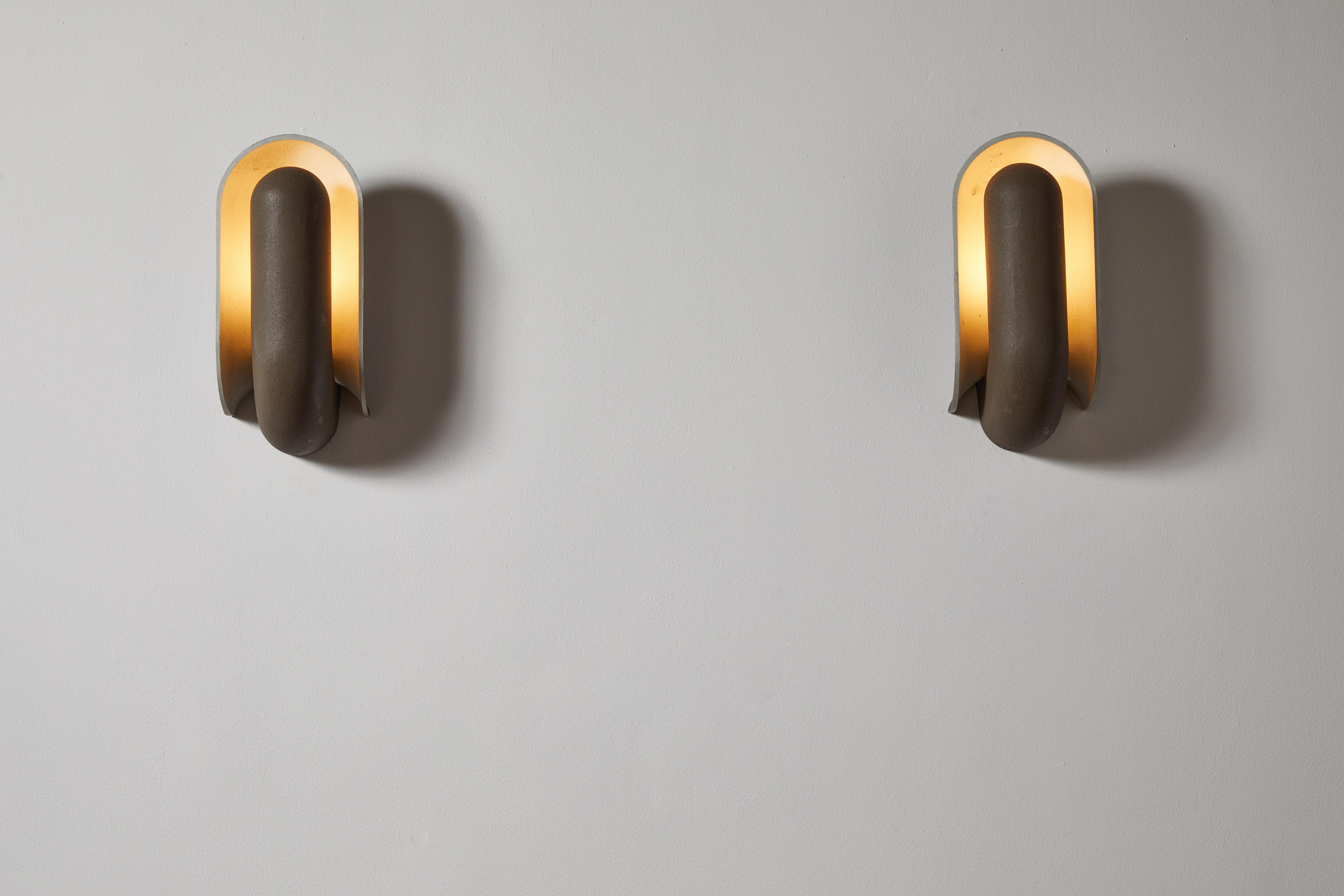 Pair of Schelpdier sconces by Piet Cohen for RAAK. Designed and manufactured in the Netherlands, circa 1960s. Original aluminum and textured paint. Rewired for U.S. standards. Retains original manufacturer's label. These fixtures have one socket.