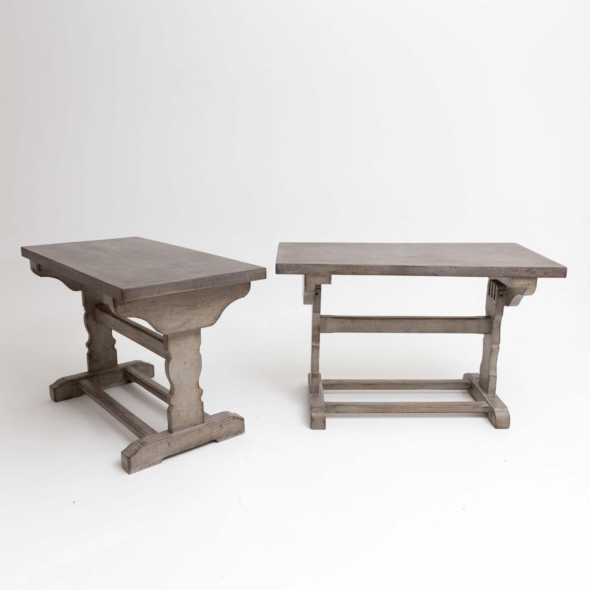 Pair of softwood desks with H-shaped brace wavy cut out legs. The gray setting is new and decoratively rubbed through.