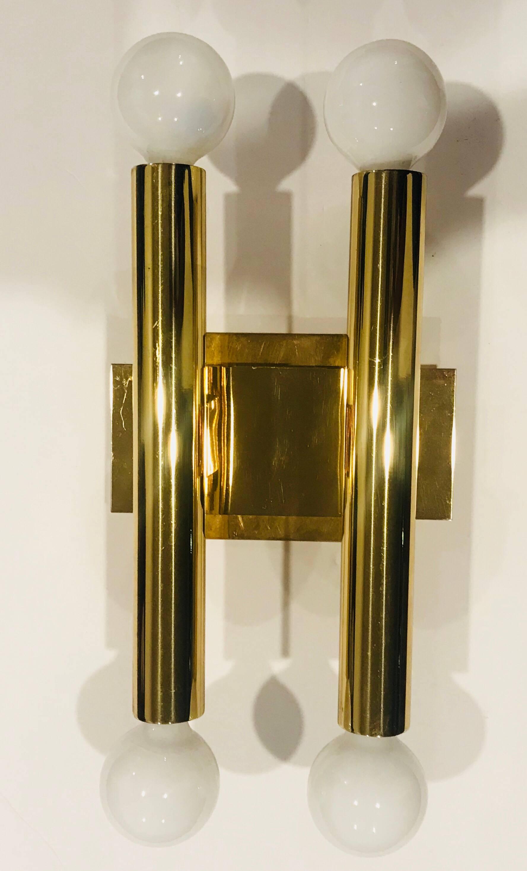 A pair of high polished golden brass modern tube sconces designed by the famed Italian lighting company, Sciolari. Four E12 candelabra 60w sockets each. Newly rewired with backplates.