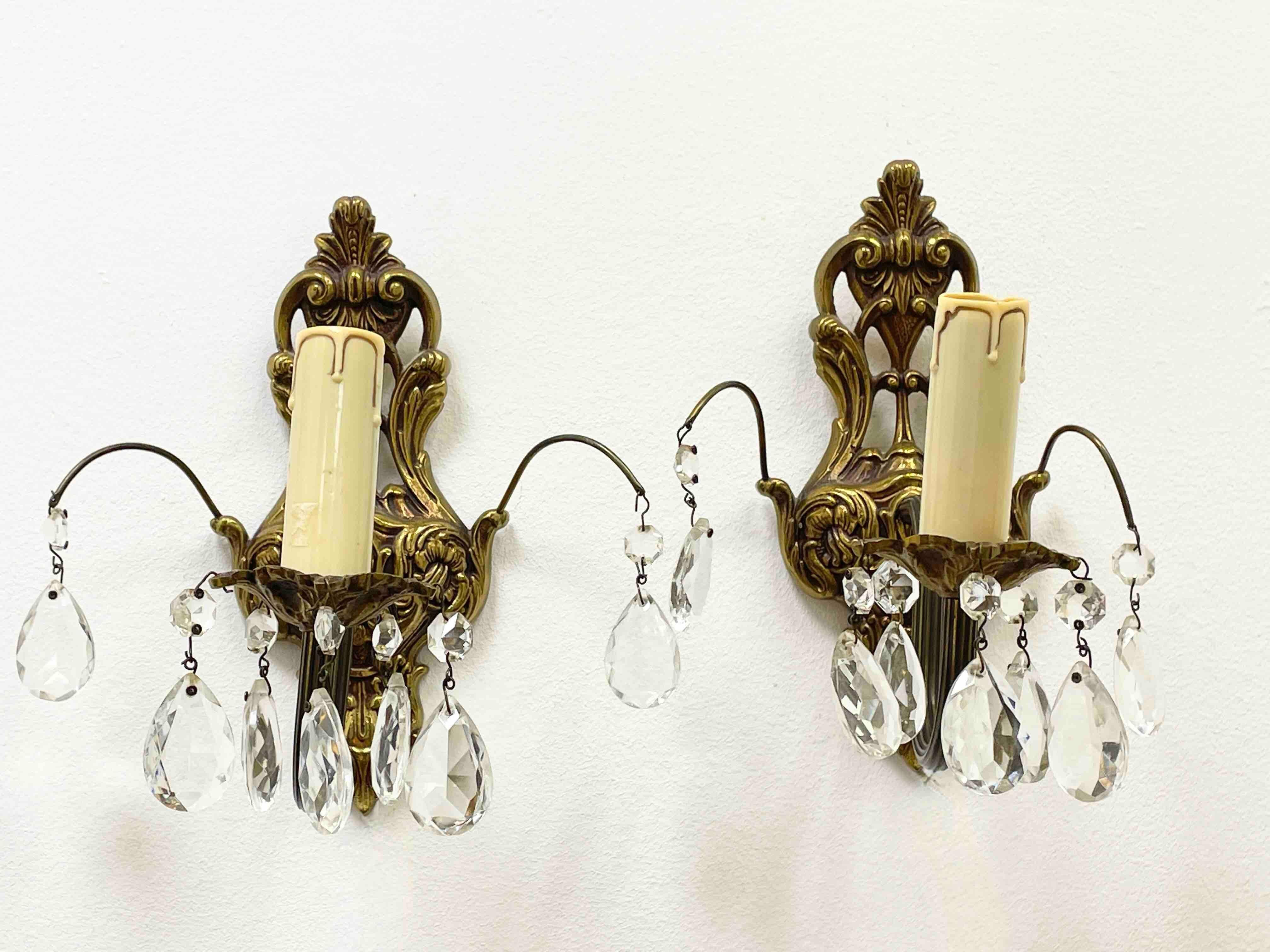 Pair of nice sconces. Each fixture requires a European E14 candelabra bulb, bulb up to 40 watts. Each wall light has a beautiful patina and gives each room an eclectic statement. Made of bronze metal and crystal glass. Nice addition to any room.