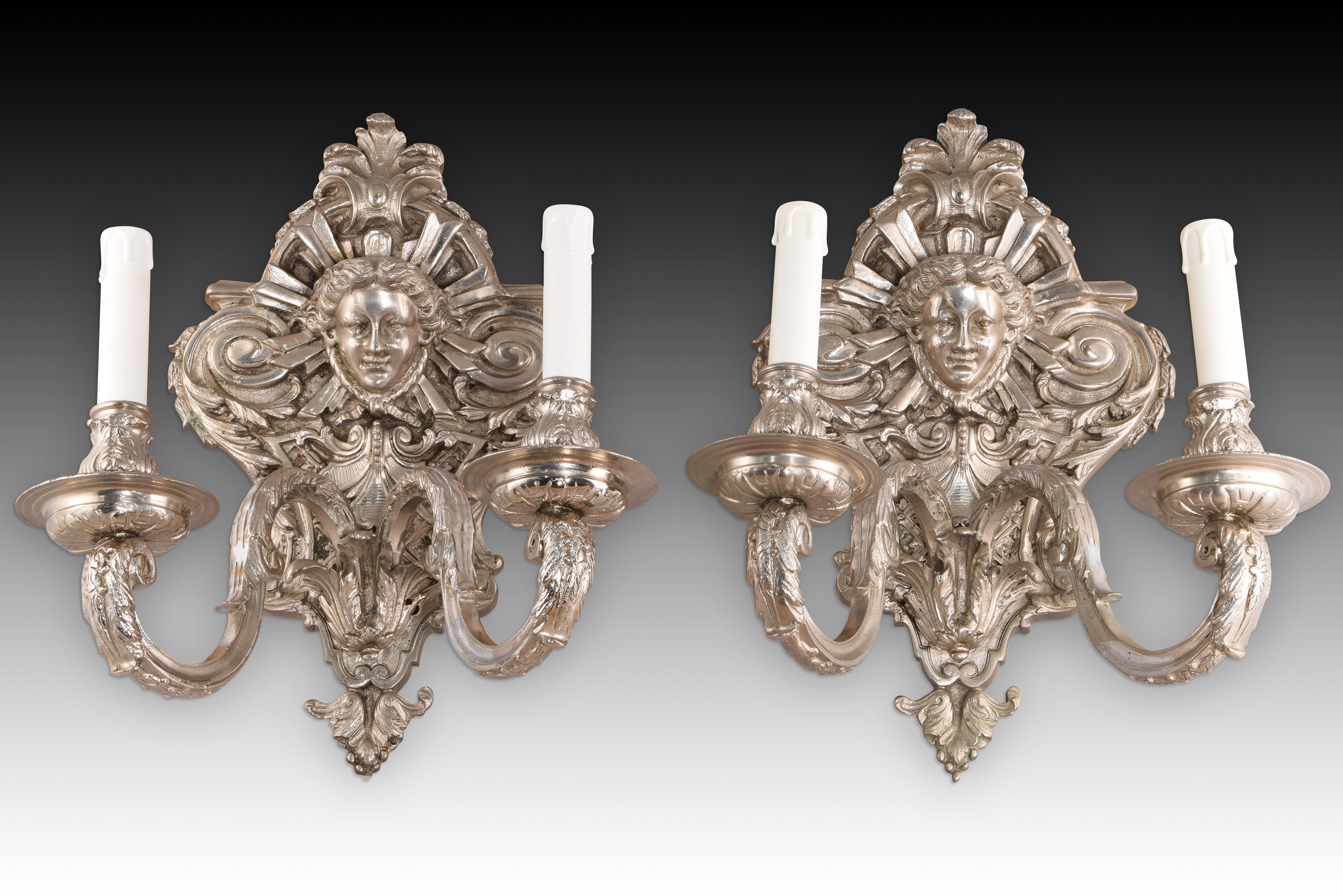 Pair of sconces. Bronze. Silver finish.
Pair of wall sconces with two lights each, decorated with figurative, vegetal and
decorated with figurative, vegetal and architecturalarchitectural elements inspired by certain 19th century Rococo
19th century