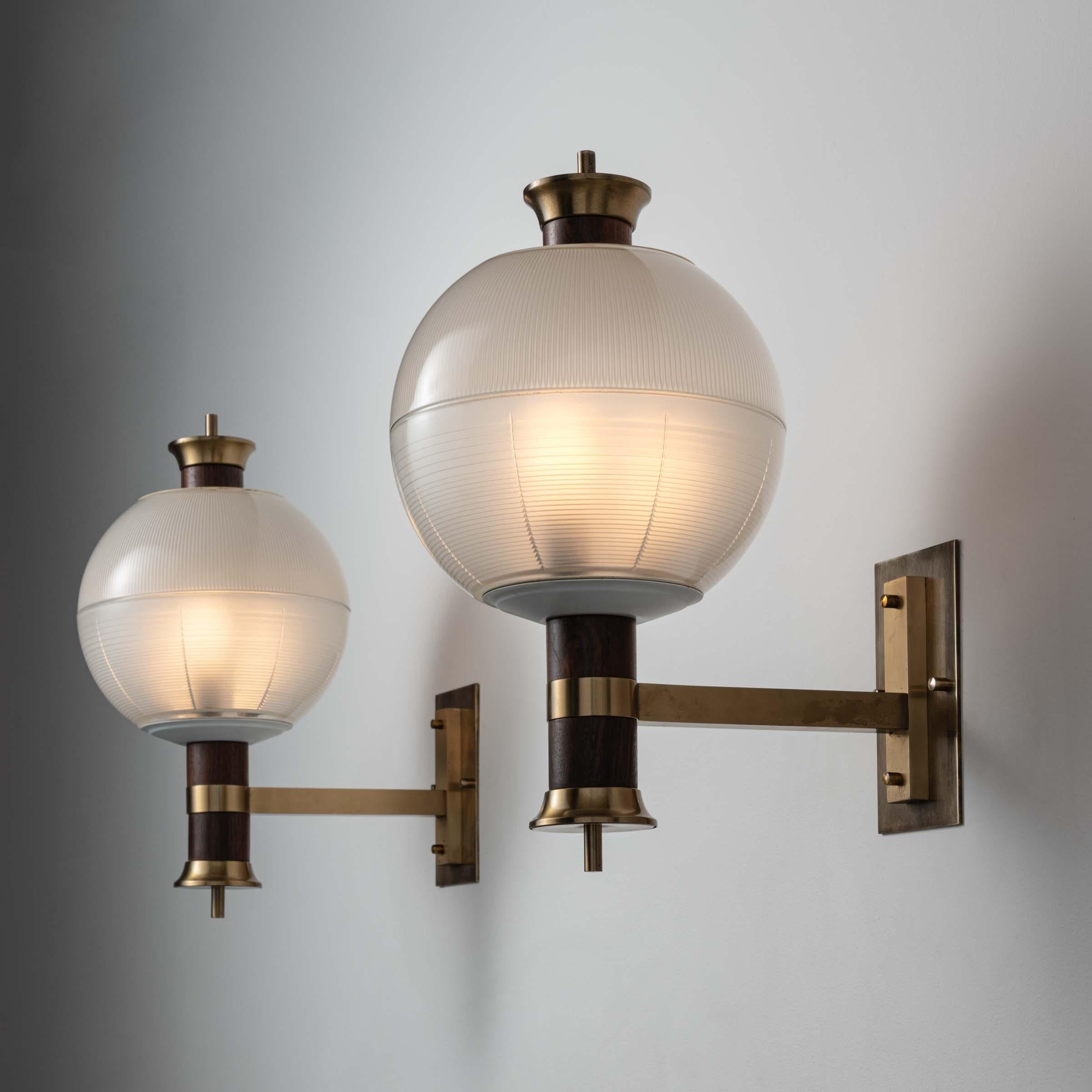 Pair of sconces by Michele Achilli, Daniele Brigidini, Guido Canella. Designed and manufactured in Italy, circa 1960's. Holophane glass, brass. Custom brass backplate. We recommend three E14 candelabra 25w maximum bulbs per sconce. Bulbs not