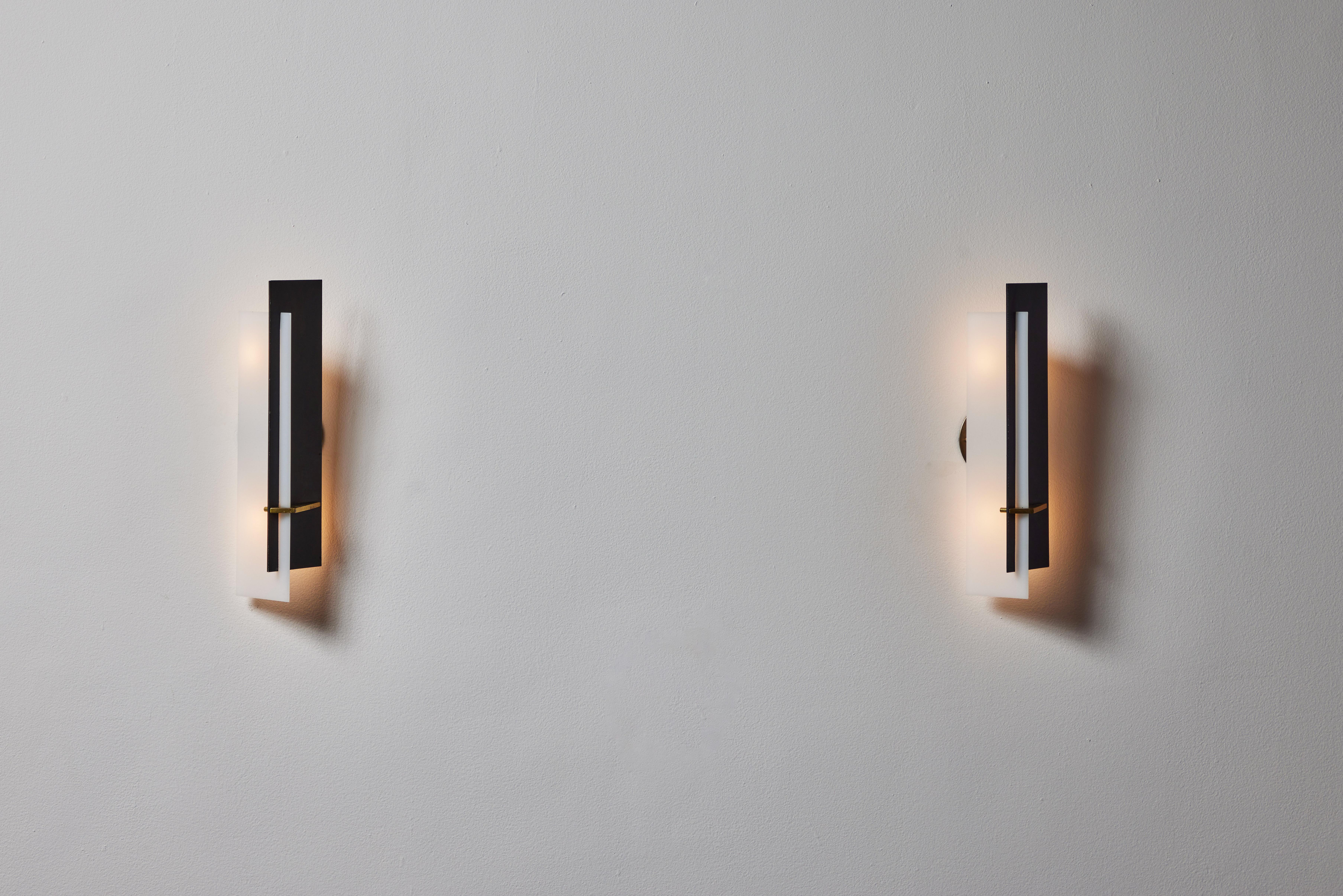 Pair of sconces by Angelo Brotto for Esperia. Designed and manufactured in Italy, circa 1960. Lacquered metal, brass, custom brass backplates and opal methacrylate. Original label. Wired for U.S. standards. We recommend two E14 40w maximum bulbs per
