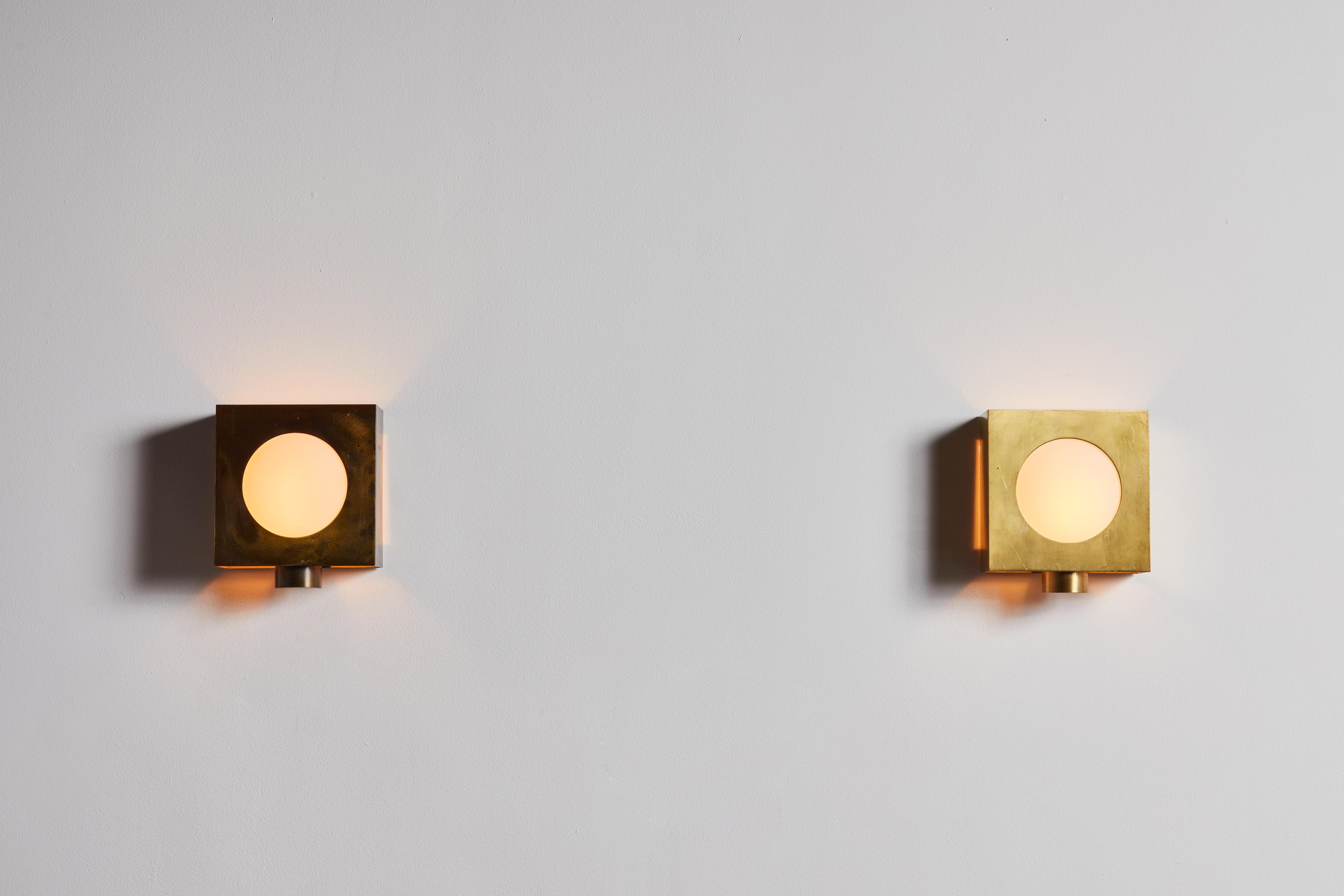 Pair of sconces by Arredoluce. Manufactured in Italy, circa 1950s. Brass, glass. Rewired for U.S. junction boxes. Retains original manufacturers label. Each sconces takes one E27 60w maximum bulb. Bulbs provided as a onetime courtesy.
