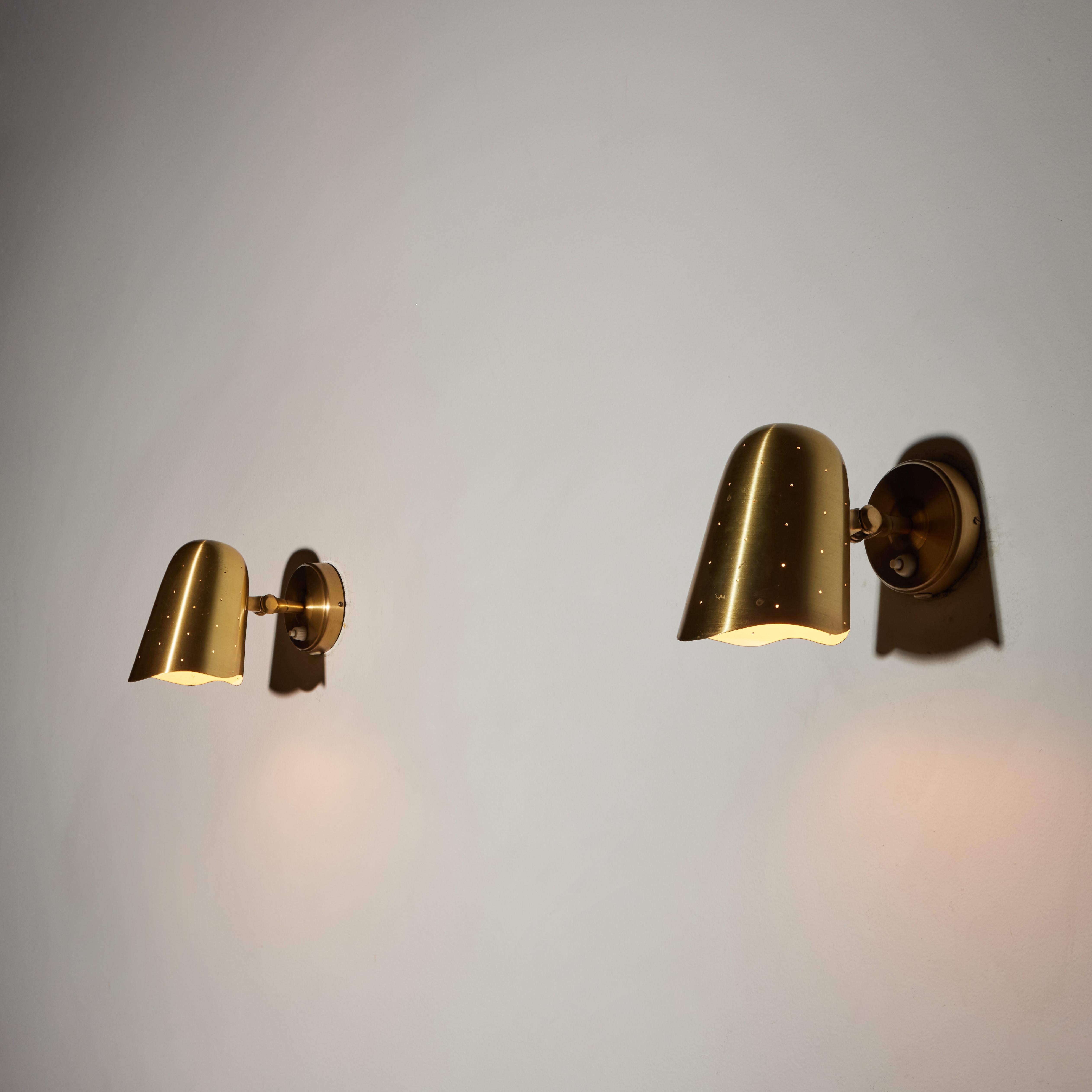 Pair of sconces by Boréns Borås. Manufactured in Sweden, circa 1950's. Brass shades articulate to various positions. Rewired for U.S. standards. We recommend one E27 75w maximum bulb per fixture. Bulbs not provided.