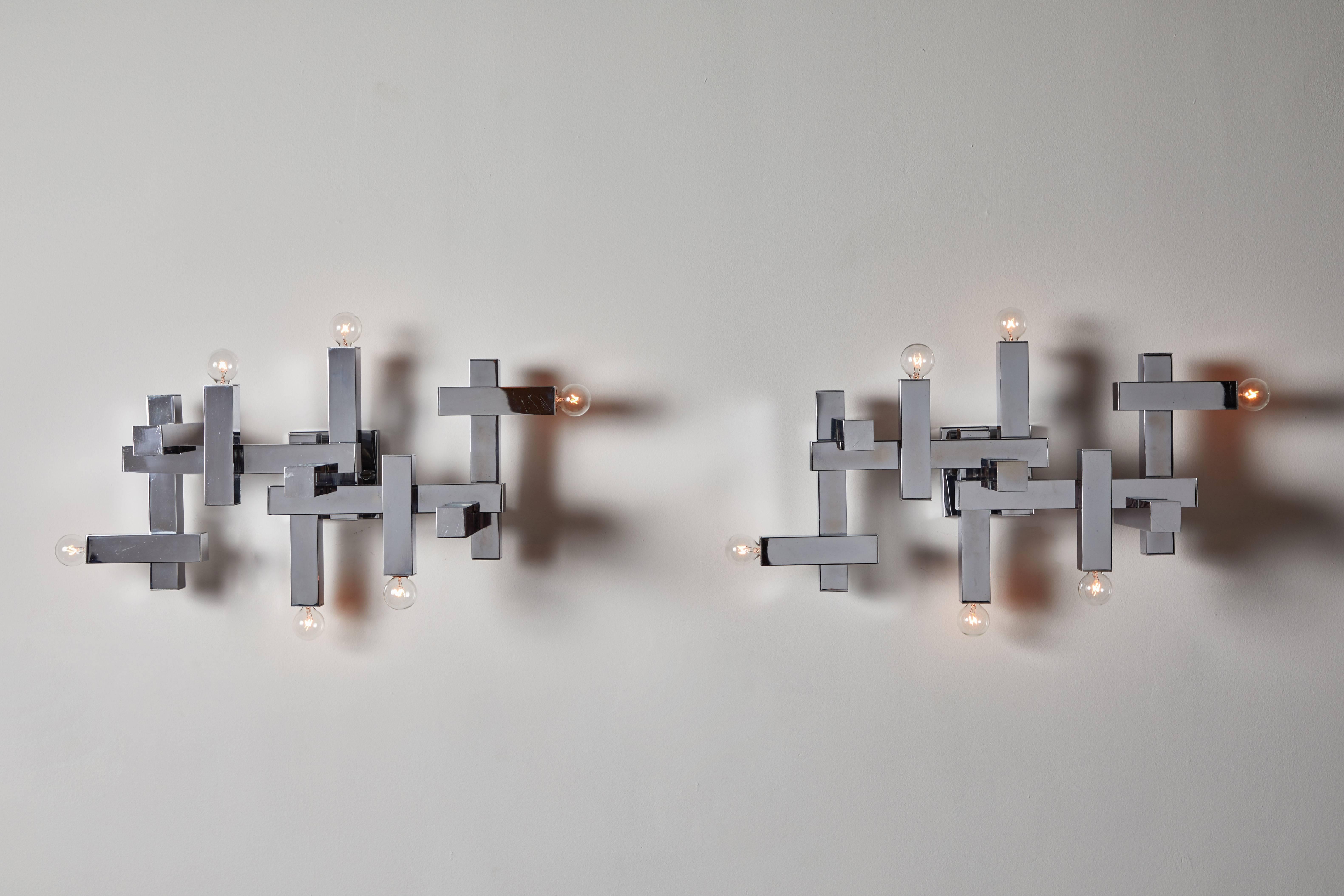 Pair of sconces by Gaetano Sciolari. Designed and manufactured in Italy, circa 1960s. Metal plated chrome. Rewired for US junction boxes. Each light takes six 25w maximum American candelabra bulbs.
