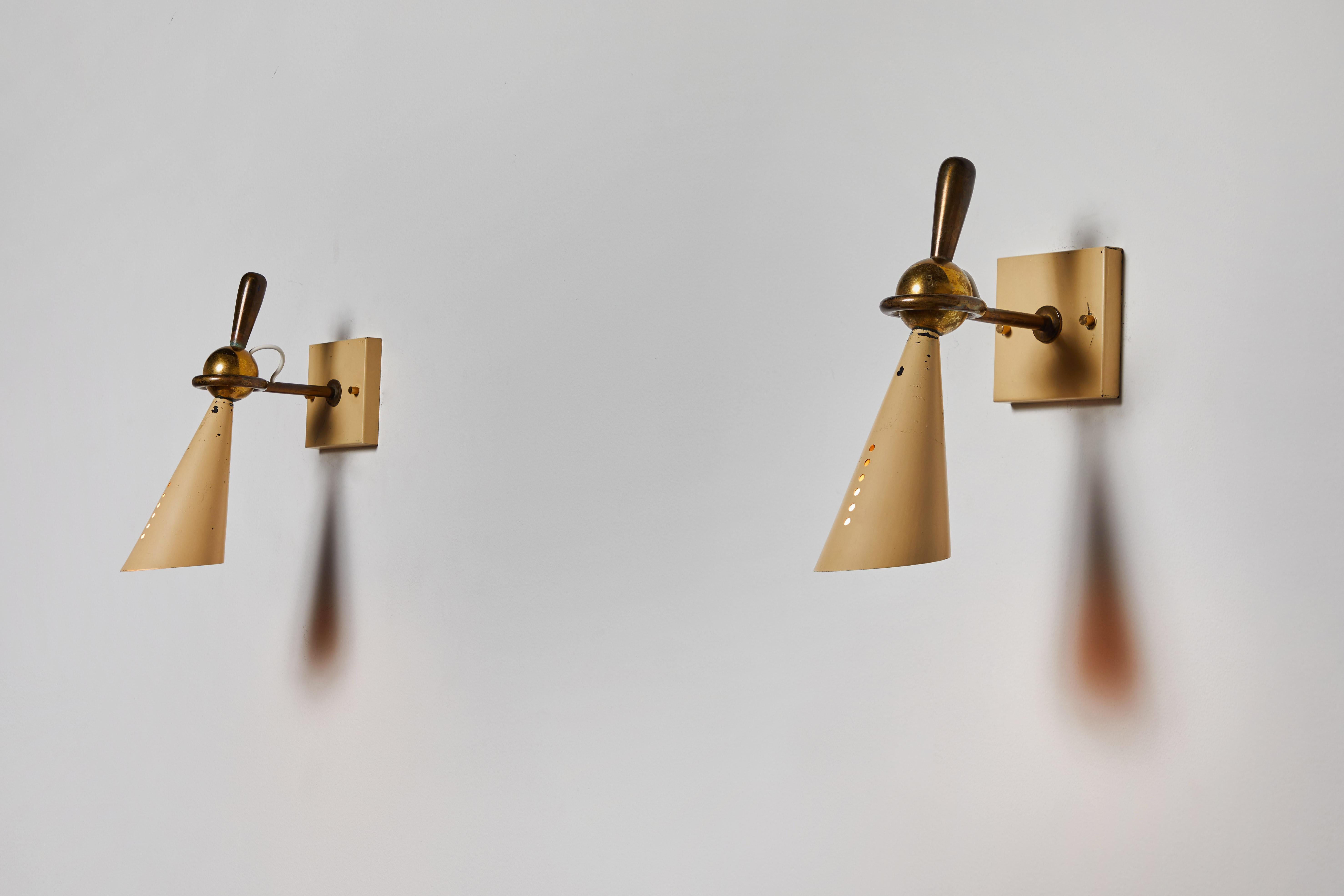Pair of Sconces by Greco. Manufactured in Italy circa 1950s. Enameled metal and brass. Original backplates. Rewired for U.S. junction boxes. Sconces articulate in a circular motion by way of ball joint. Each sconce takes one E27 75w maximum bulb.
