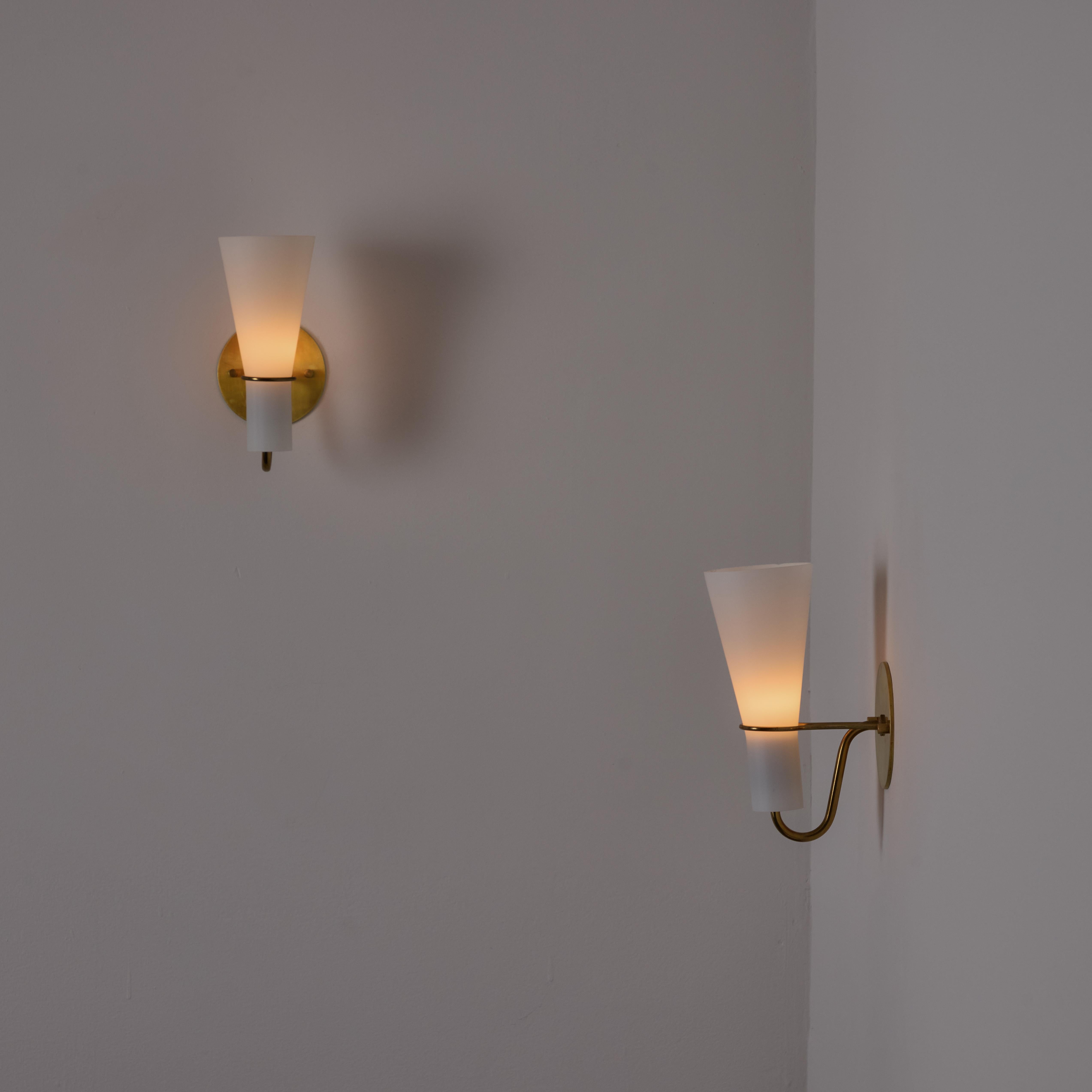 Pair of Sconces by Hans Bergström for ASEA. Designed and manufactured in Sweden, circa the 1950s. Tulip opaline glass nestles into a polished brass holder. Each sconce holds a single E14 socket-type, adapted for the US. Rewired for the US. Sold as a