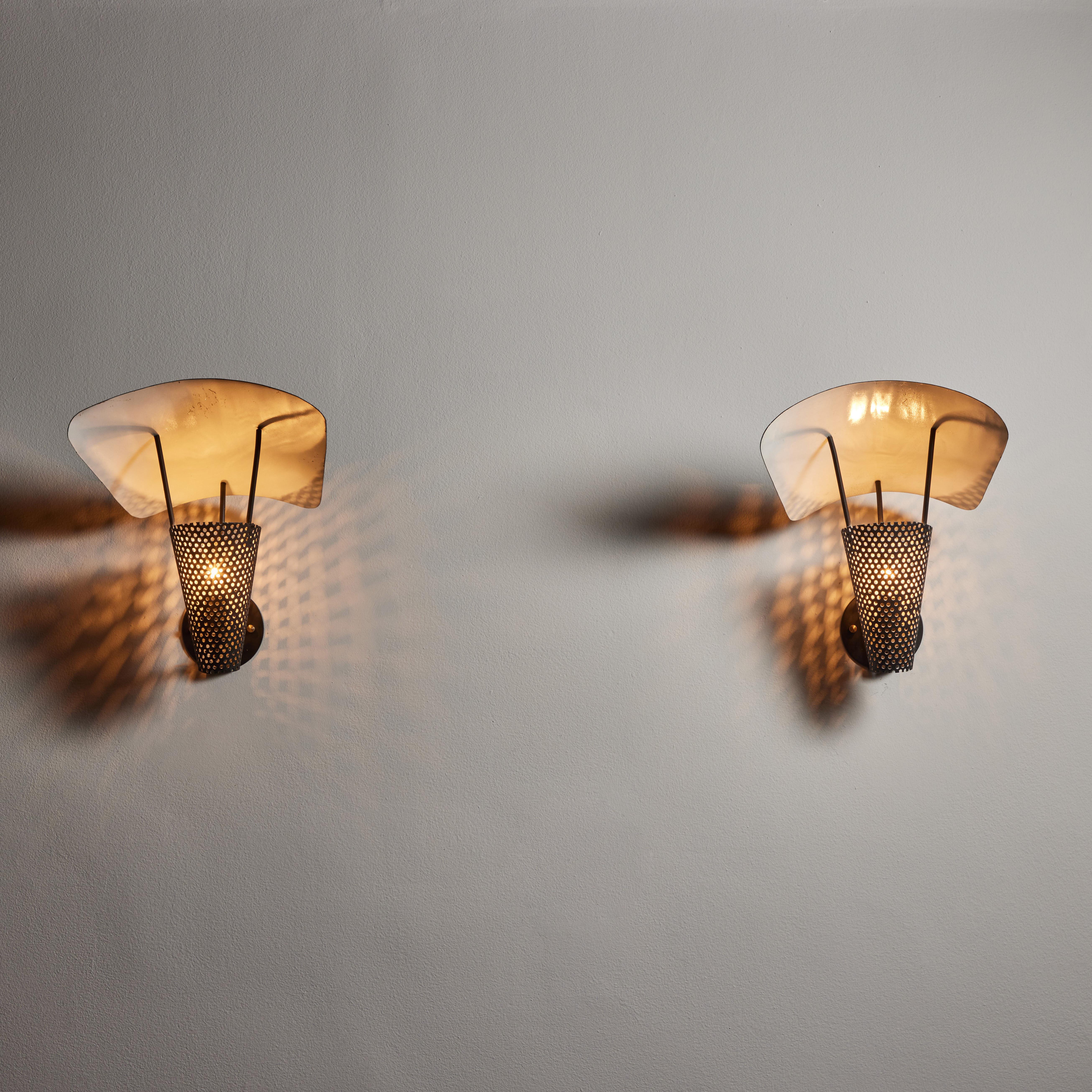Pair of sconces by Jacques Biny. Designed and manufactured in France, circa 1950's. Enameled metal, custom backplates. Wired for U.S. standards. We recommend on E12 100w maximum American candelabra bulb. Bulbs not included.
