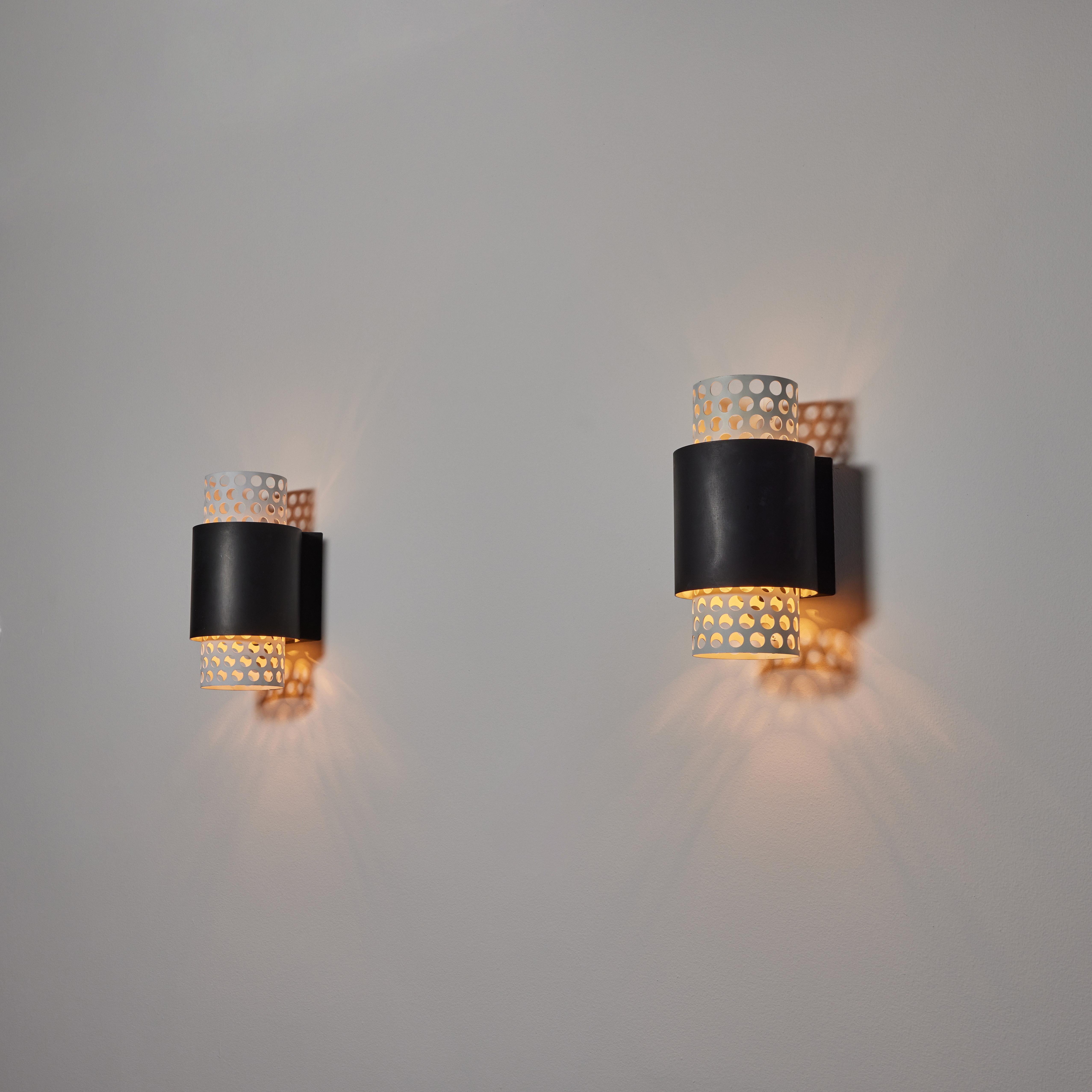 Pair of sconces by Lightolier. Manufactured in the U.S. circa 1950's. Enameled aluminum. We recommend one E27 100w maximum bulb per fixture. Bulbs not included.