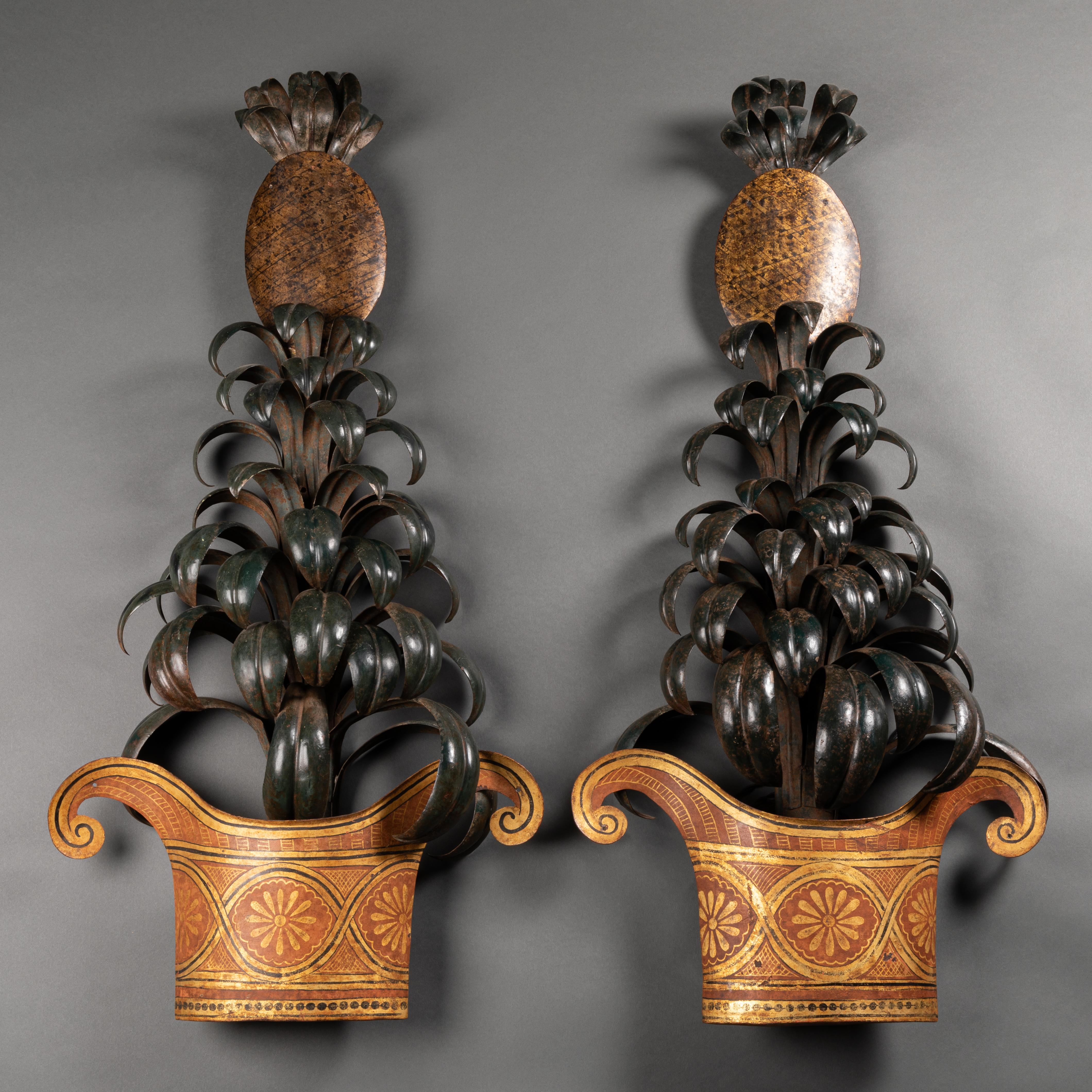 Pair of sheet iron sconces with vases and pineapples. Trompe l’oeil painting. Maison Jansen, circa 1950. Wired to the EU standard.