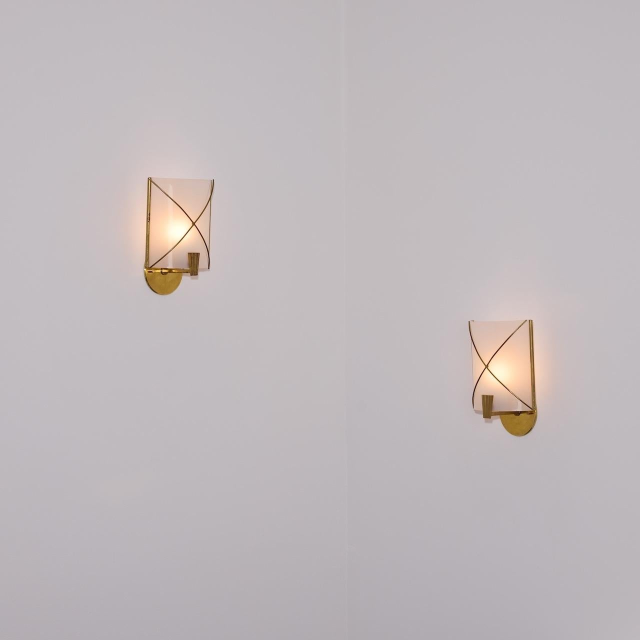 Pair of Sconces by Maison Lunel (Fr. 1958)

Acrylic shields with a brass cross mark at the center diffuser and a very nice pleated bottom finial.  Each sconce holds a single e14 socket type, adapted for the US. We recommend a 25-40w max bulb or LED