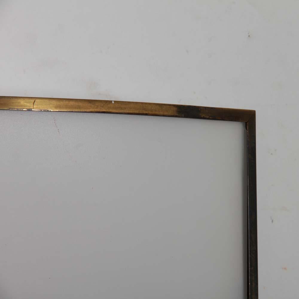 This wall lamp was designed by Michel Boyer in 1978. It is the Screen model published by Verre Lumière. This model is in brass and opal glass. This pair of lights is in good original condition.