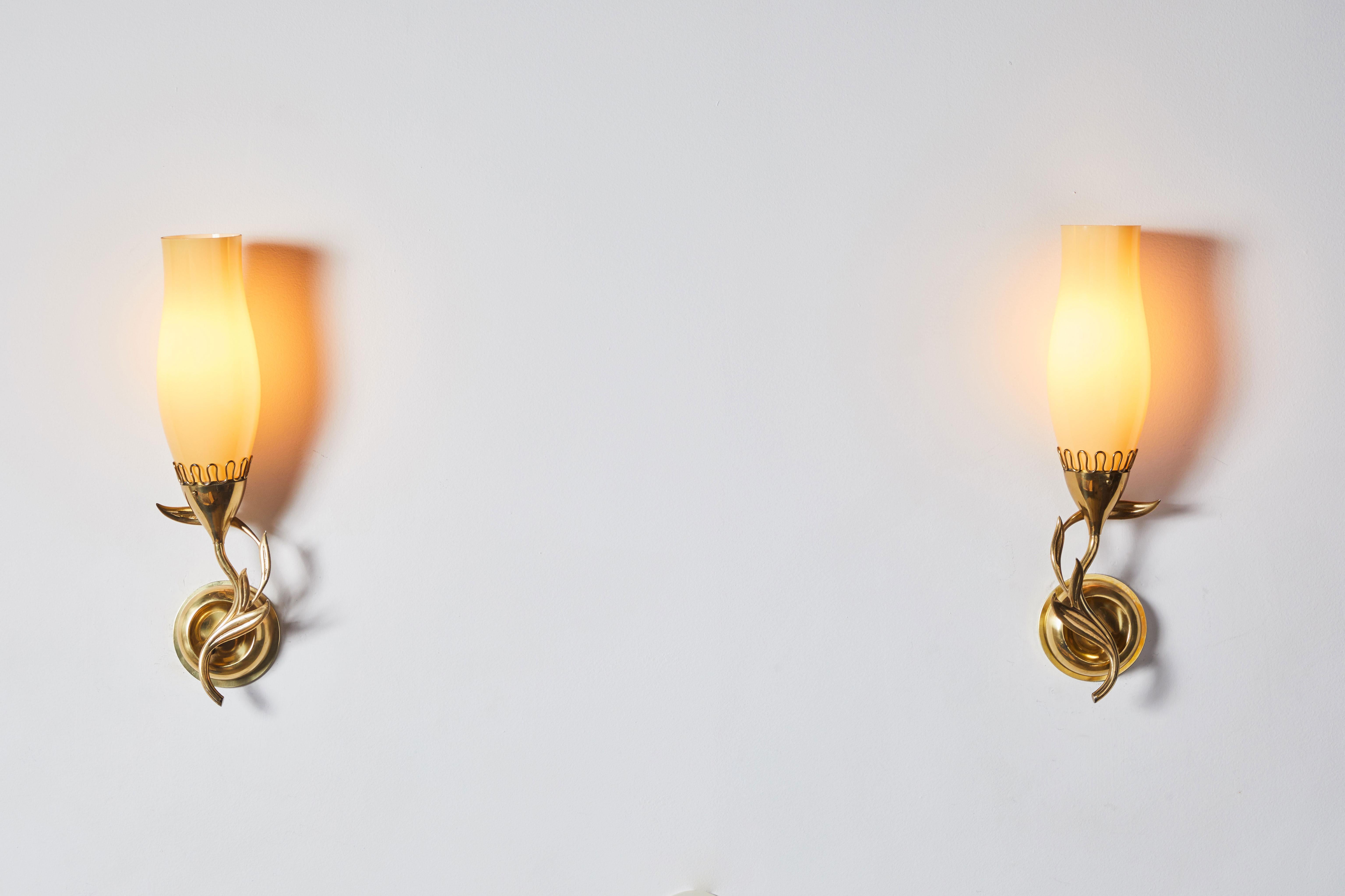 Pair of sconces by Paavo Tynell for Idman Oy. Designed and manufactured in Finland, circa 1940's. Opaque glass diffusers, brass hardware. Custom brass backplates. Rewired for US junction boxes. Each sconce takes one E27 75w maximum bulb.
 
