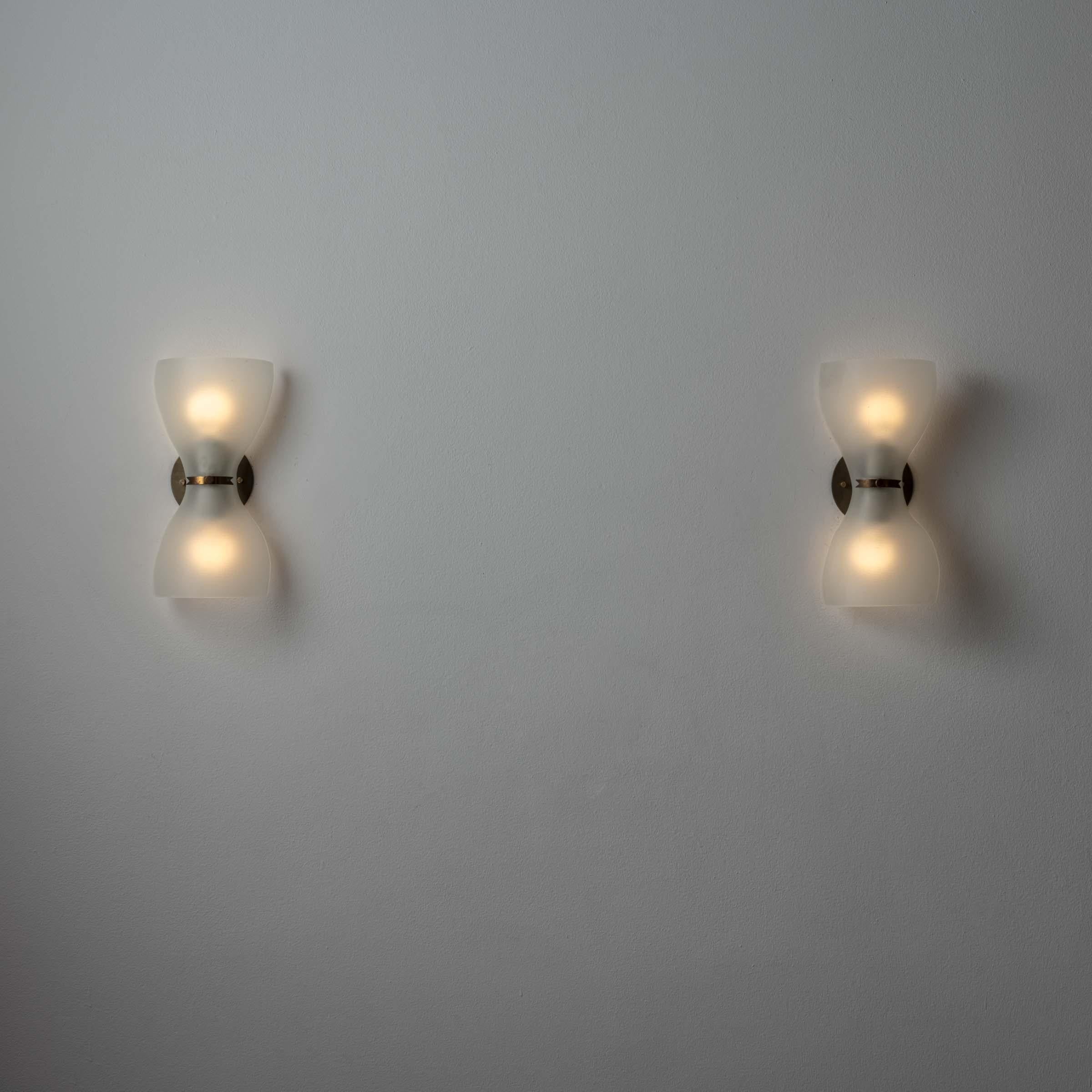 Pair of Sconces by Pietro Chiesa for Fontana Arte. Designed and manufactured in Italy, circa 1940's. Opaline glass, brass. Custom brass backplates. Wired for U.S. standards. We recommend two E14 candelabrab 25w maximum bulbs per sconce. Bulbs not