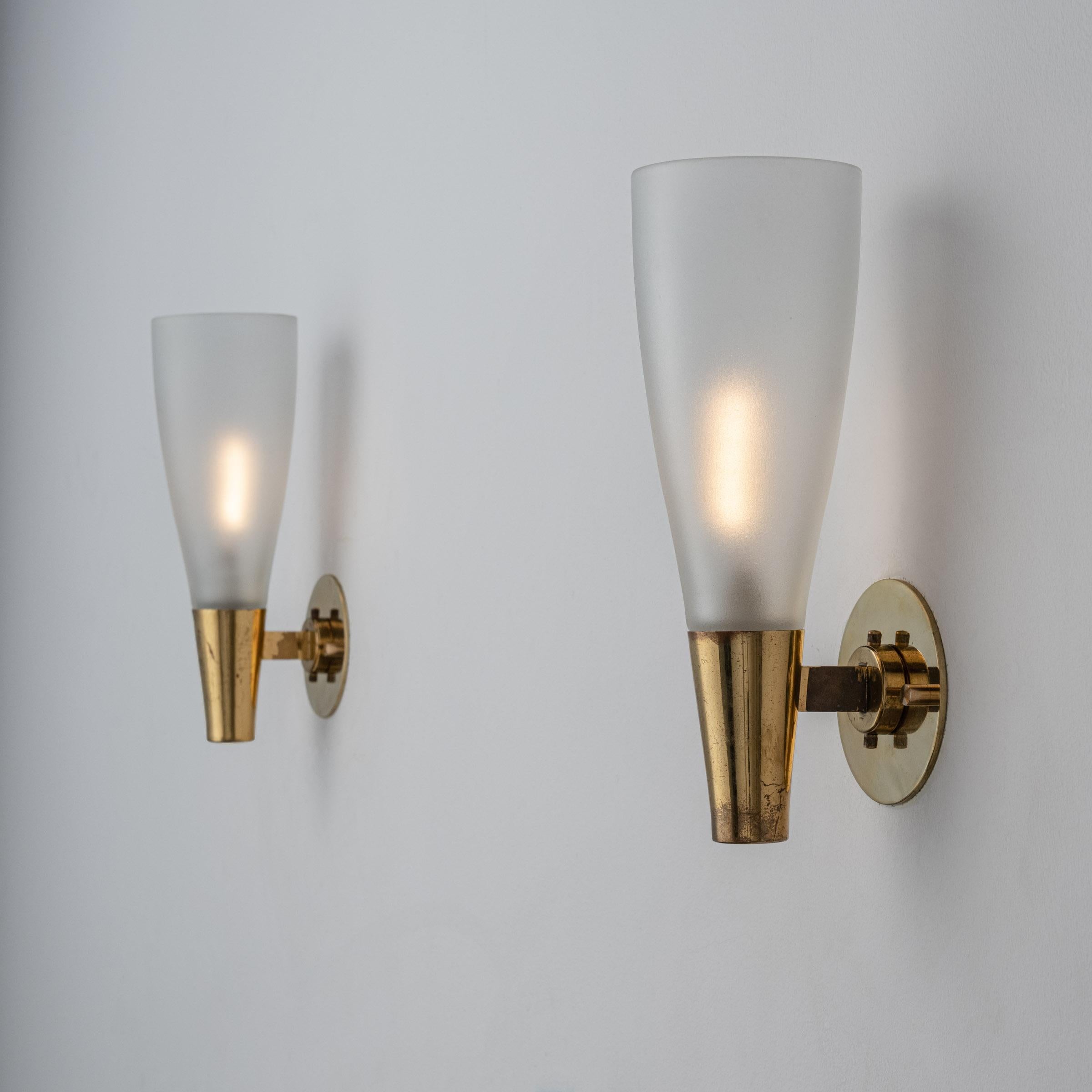 Pair of Model 1537 Sconces by Pietro Chiesa for Fontana Arte. Designed and manufactured in Italy, circa 1950's. Brass, glass. Rewired for U.S. standards. We recommend. Lamping: 120v 2 Qty E14 Sockets with 40w Frosted Bulbs/ Lightbulbs not included.