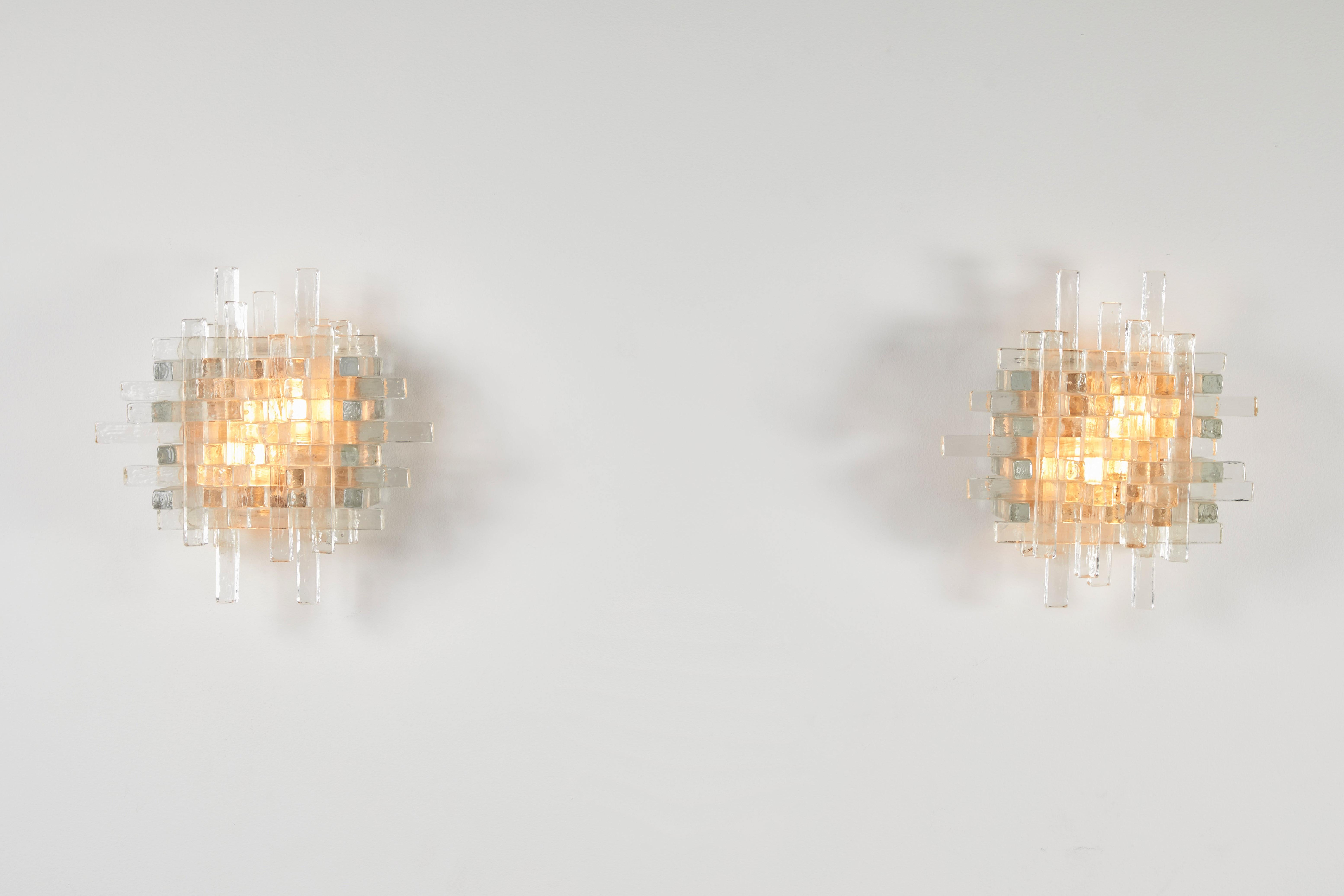 Pair of sconces by Poliarte. Manufactured in Italy, circa 1960s. Textured glass, metal frame. Rewired for U.S. junction boxes. Each light takes two 40W maximum bulbs. Bulbs provided as a one time courtesy.