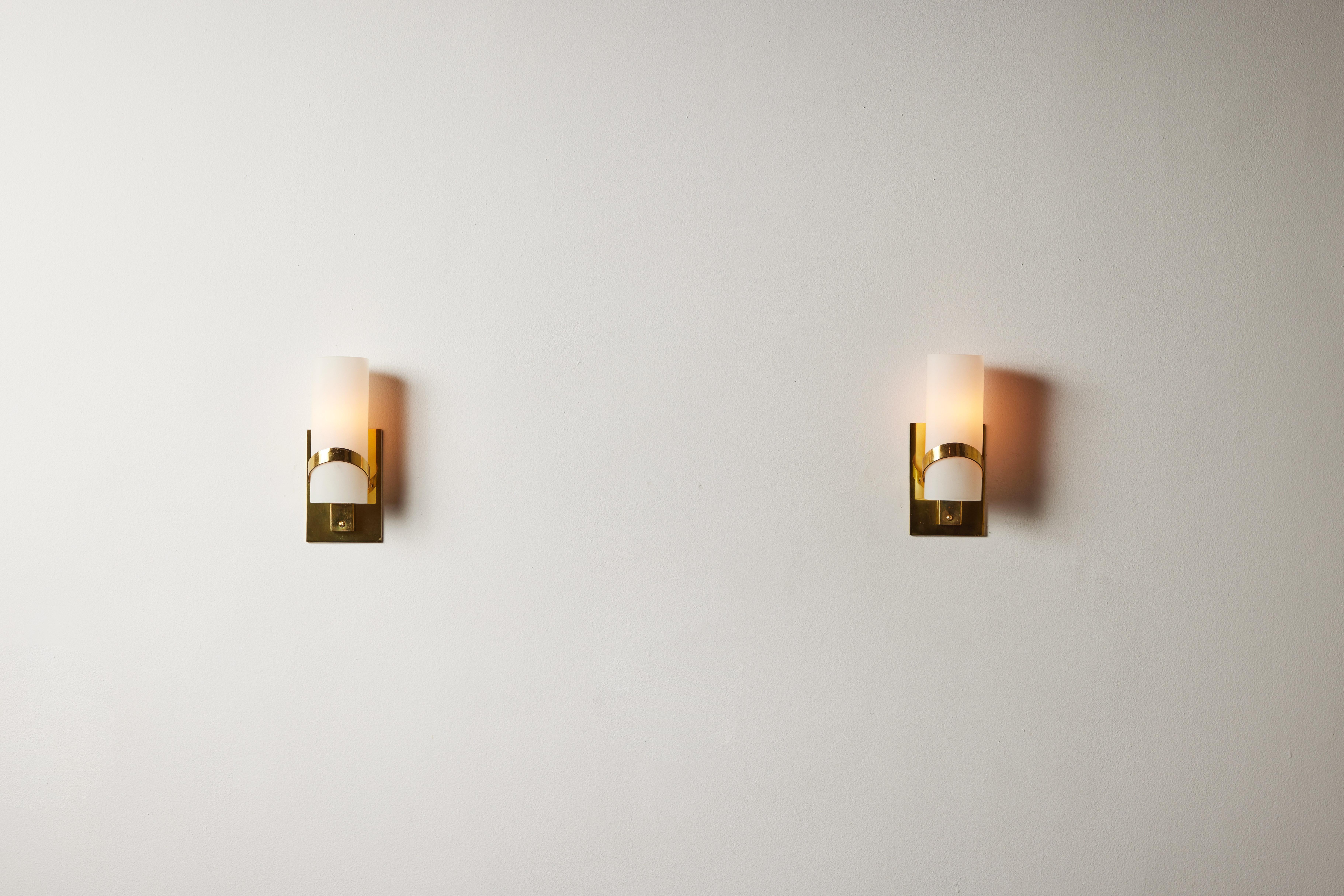 Pair of sconces by Stilnovo. Manufactured in Italy, circa 1950's. Brushed satin glass diffusers, brass. Custom brass backplate. Rewired for U.S. standards.
We recommend one E14 candelabra bulb per fixture. Bulbs provided as a onetime courtesy.
  