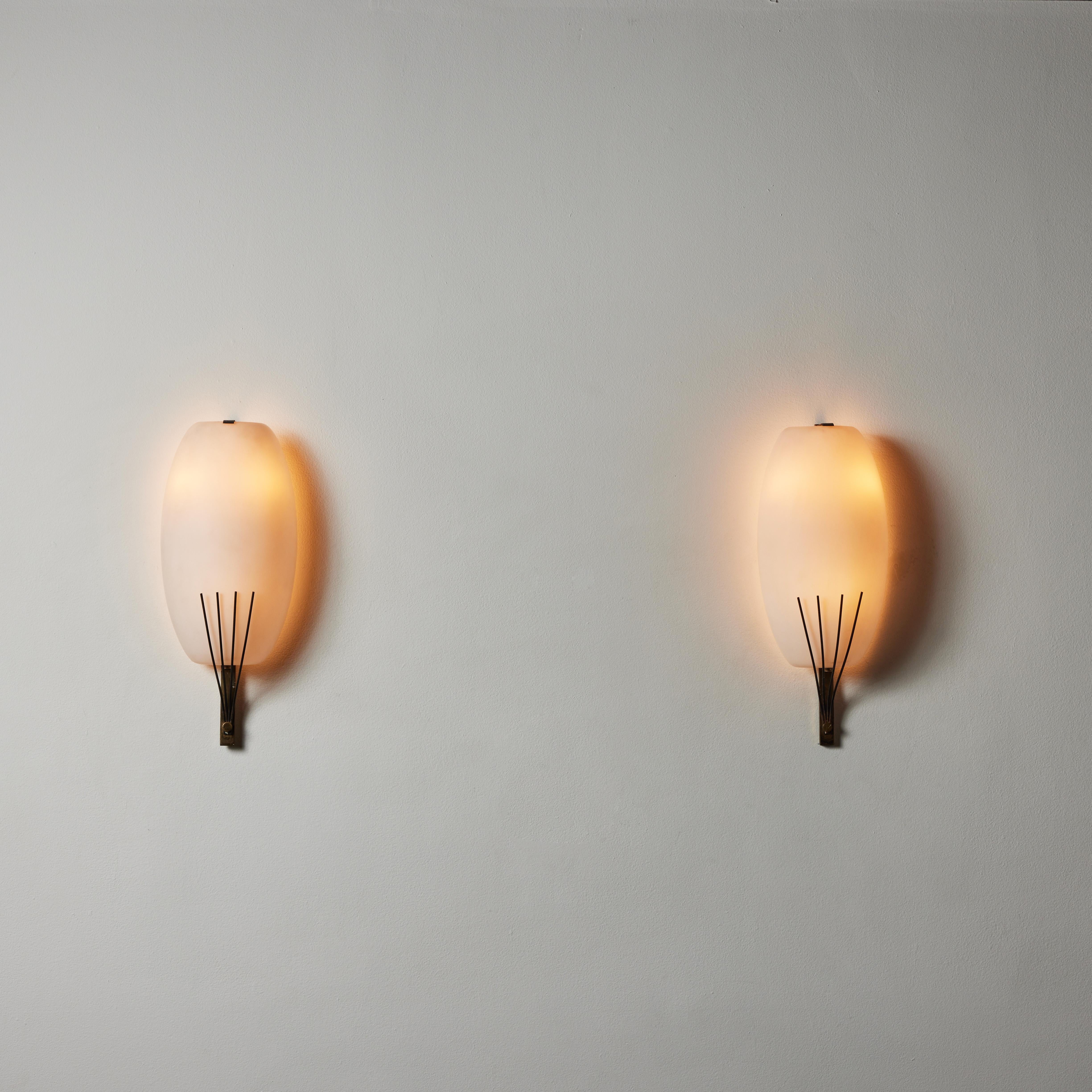 Pair of Sconces by Stilnovo. Manufactured in Italy, circa 1960's. Brushed satin glass, brass. Rewired for U.S. standards. We recommend three E12 bulbs 25w maximum bulbs per fixture. Bulbs not provided.