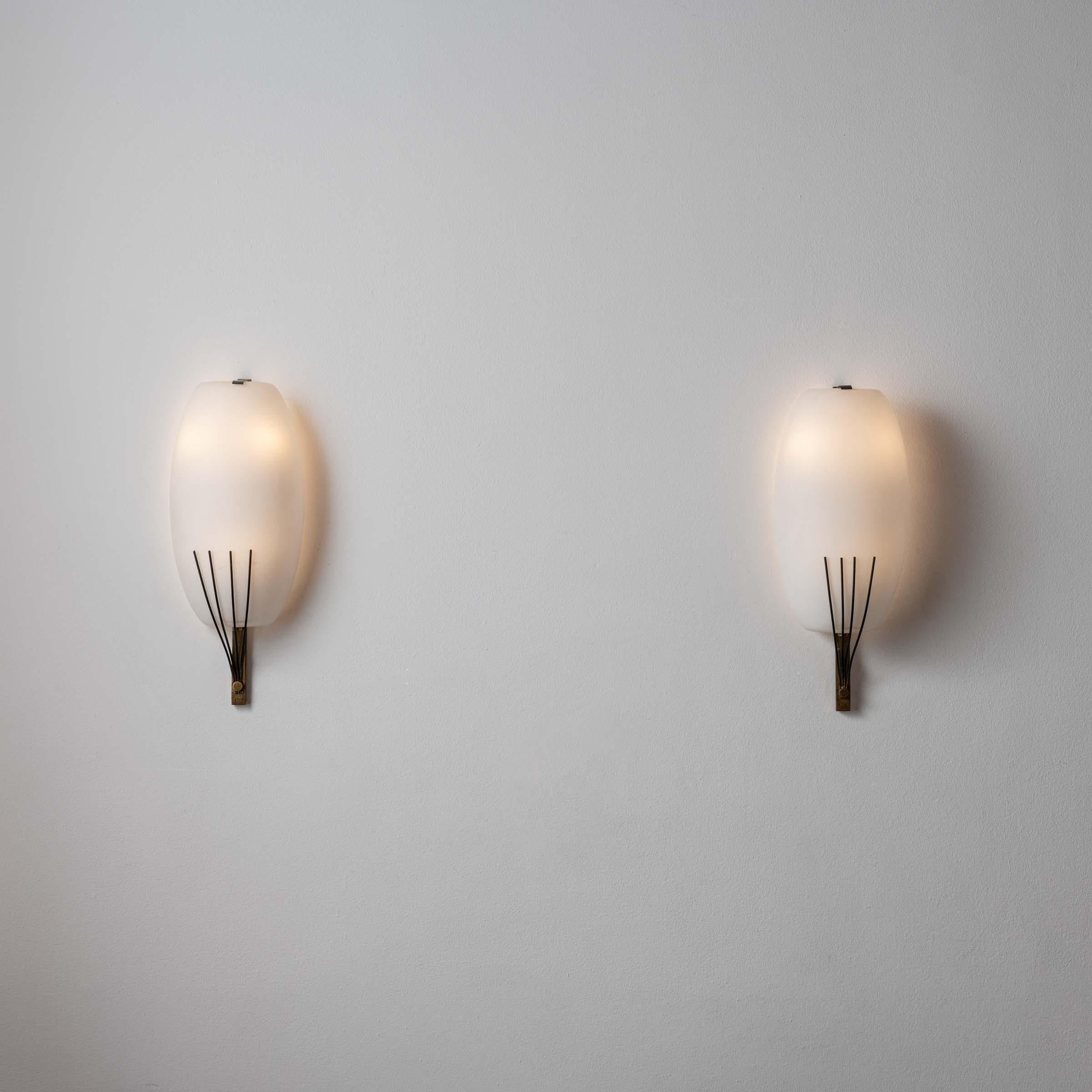 Pair of Sconces by Stilnovo. Designed and manufactured in Italy, circa 1950's. Brushed satin glass, brass. Custom brass backplates. Wired for U.S. standards. We recommend three E14 candelabra 25w maximum bulbs per sconce. Bulbs not included.