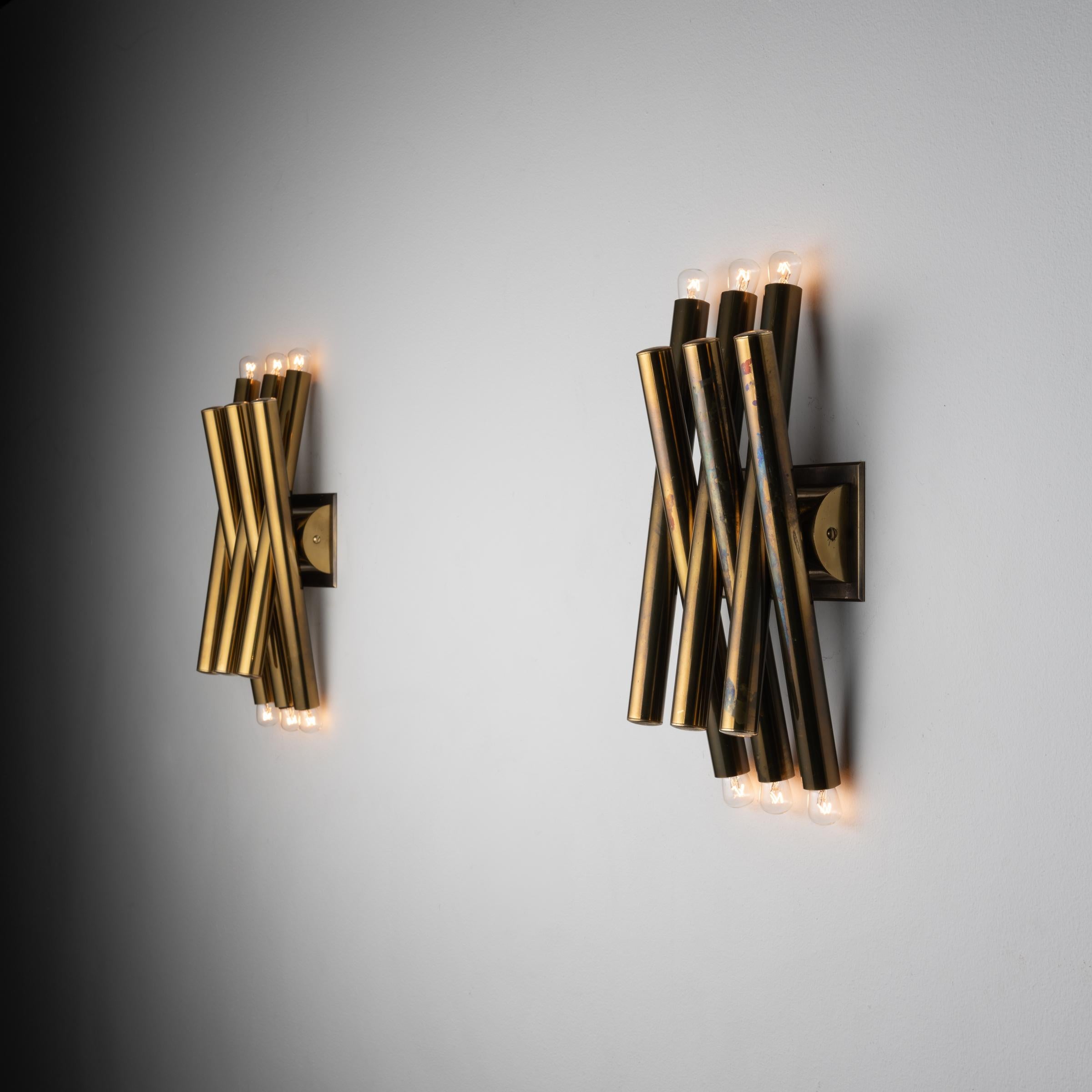 Pair of sconces by: Stilnovo. Designed and manufactured in Milan, Italy circa 1960's. Brass, custom brass sconces. Rewired for U.S. standards. We recommend six E14 15w maximum bulbs per fixture. Sold as a set. Bulbs not included.
 