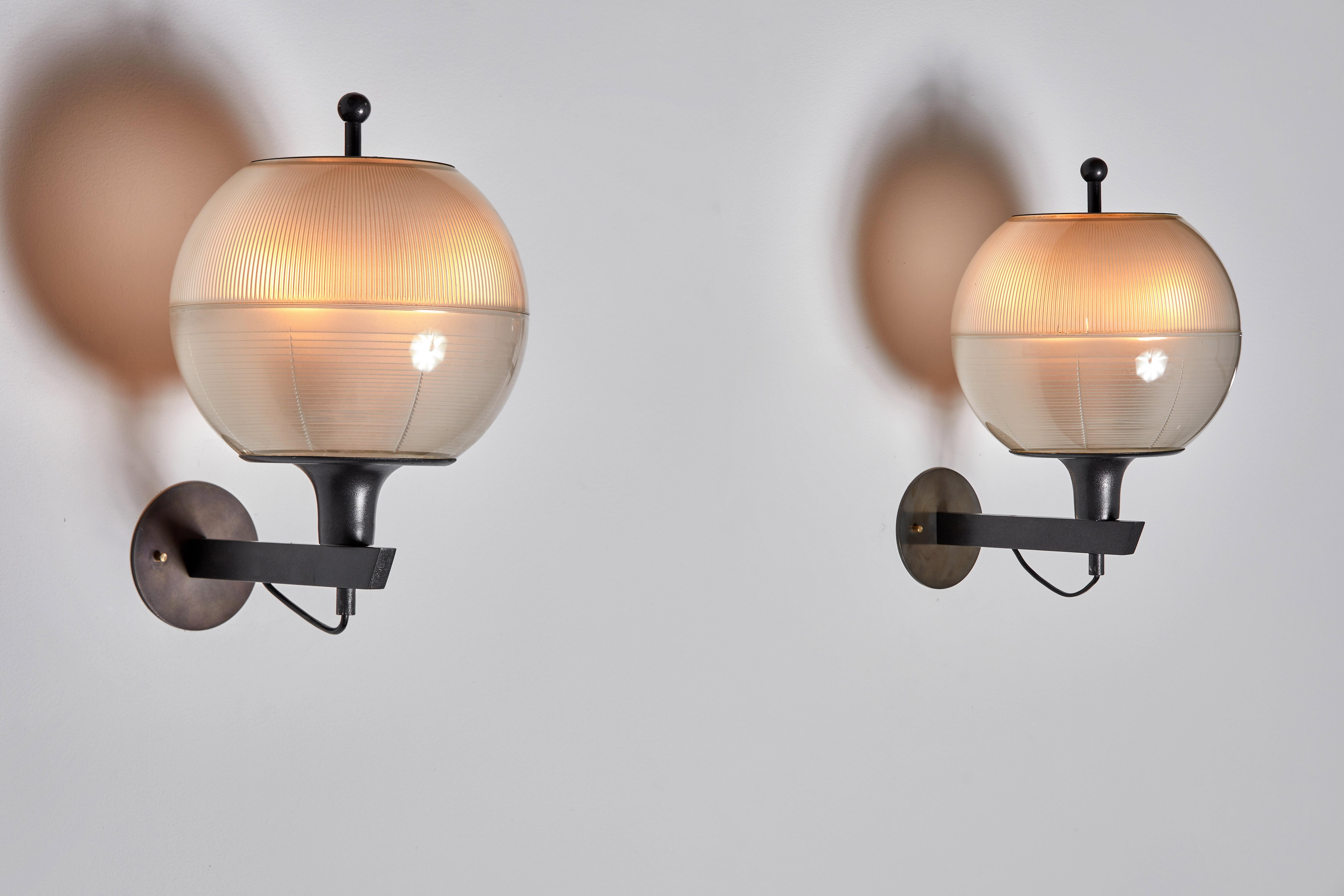 Pair of Italian Sconces. Designed and manufactured in Italy, circa 1960's. Blackened steel, Holophane glass diffuser. Custom backplates. Rewired for U.S. junction boxes. Each light takes one E27 100w maximum bulb. Bulbs provided as a one time