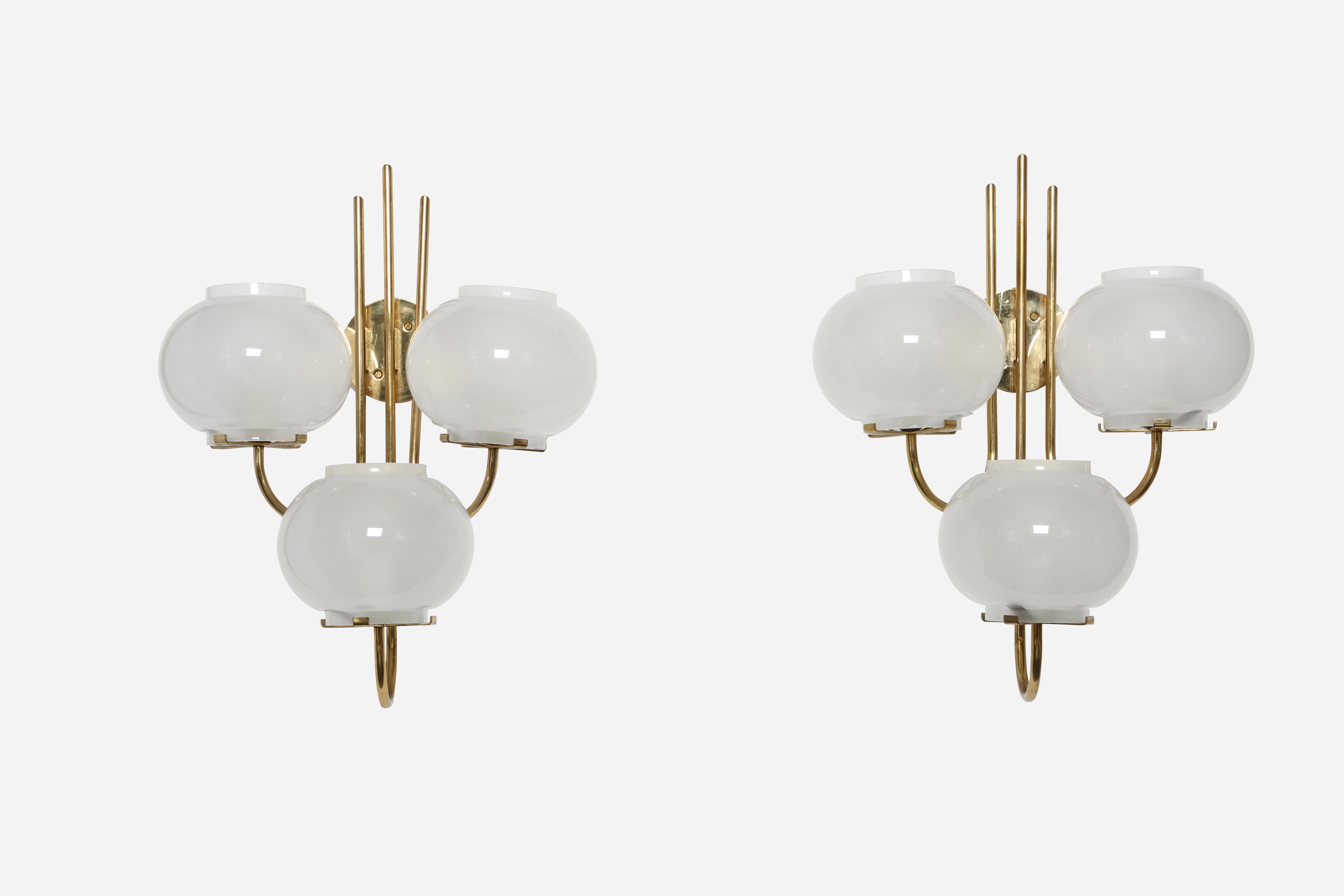 Pair of sconces by Tito Agnoli for Oluce.
Designed and made in Italy in 1960s
Brass and frosted glass.
Three candelabra base sockets each.
Complimentary US rewiring upon request.

We take pride in bringing vintage fixtures to their full glory
