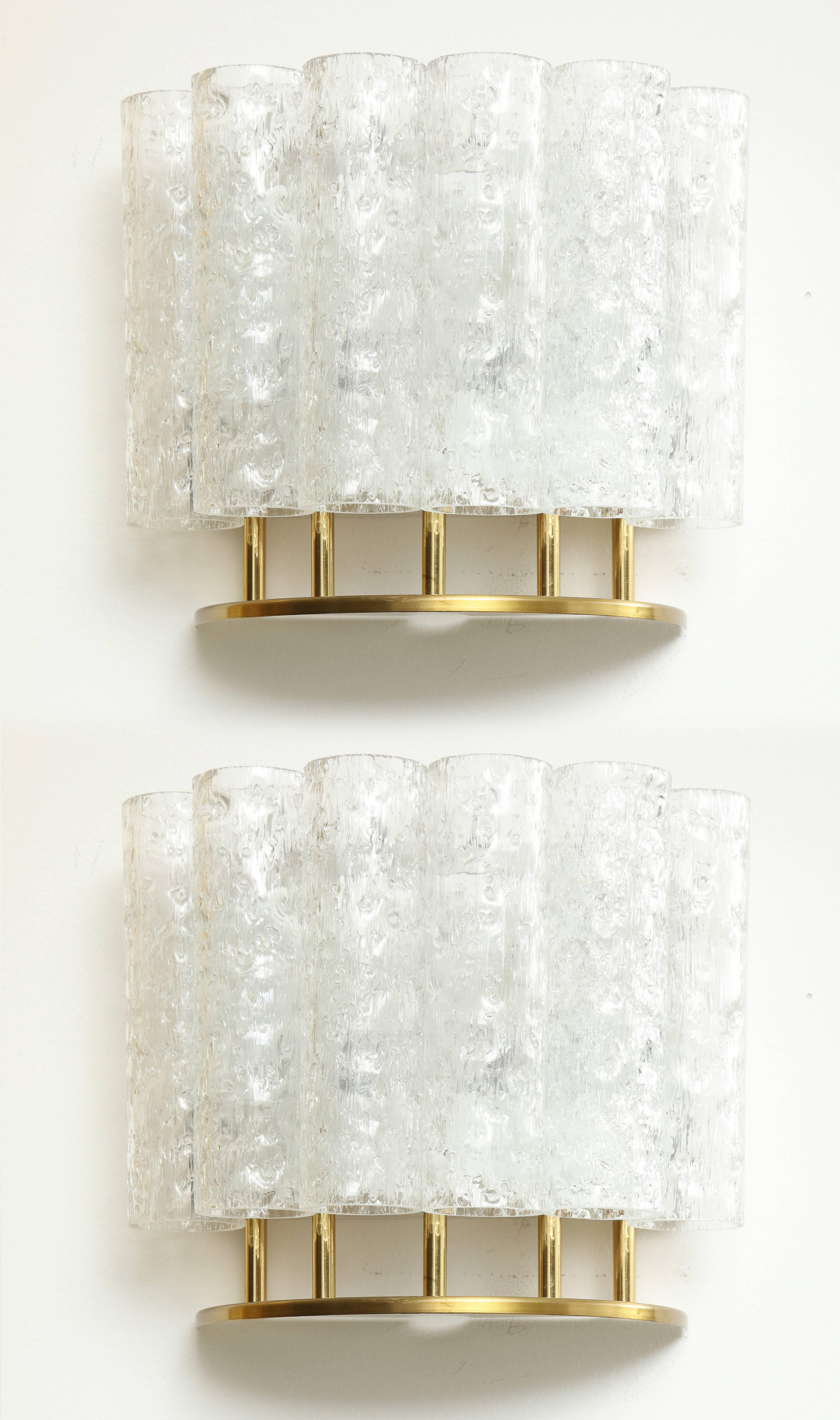 Pair of 1960s sconces by Doria lighting company.
Six frosted glass tubes form a demilune to conceal two lights which illuminate these simple and elegant sconces.
The sconces have been newly rewired.