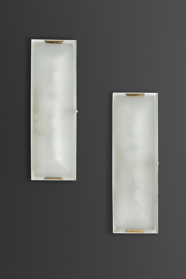 Pair of sconces with lacquered brass and textured glass diffuser. 3 candelabra based sockets.
 
