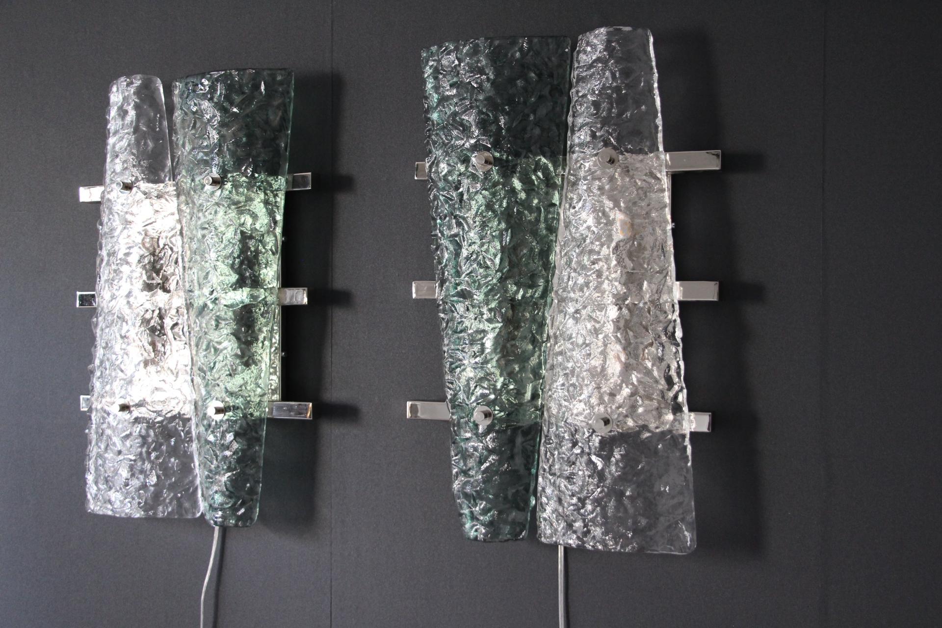 This spectacular Italian pair of geometric wall lights was entirely handcrafted in Murano by glass masters. Glass pieces are textured and look like crumbled paper. Green color is really deep and pleasant.
 They are fixed on square nickel plate and