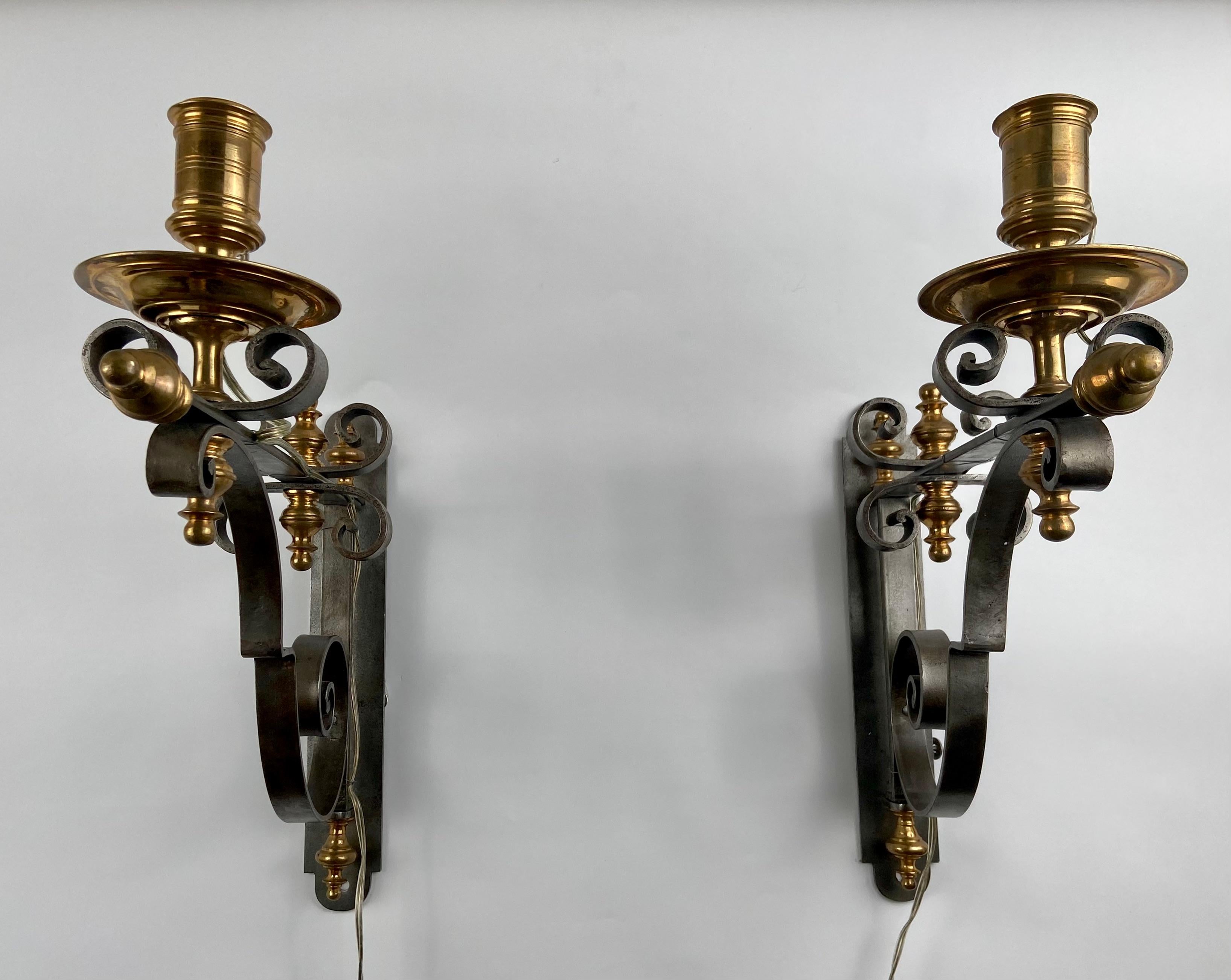 A pair of forged scones in steel and bronze. Italy, circa 1970.
They are electrified but can also used with candles.
They can be moved from left to right. No lampshades. 