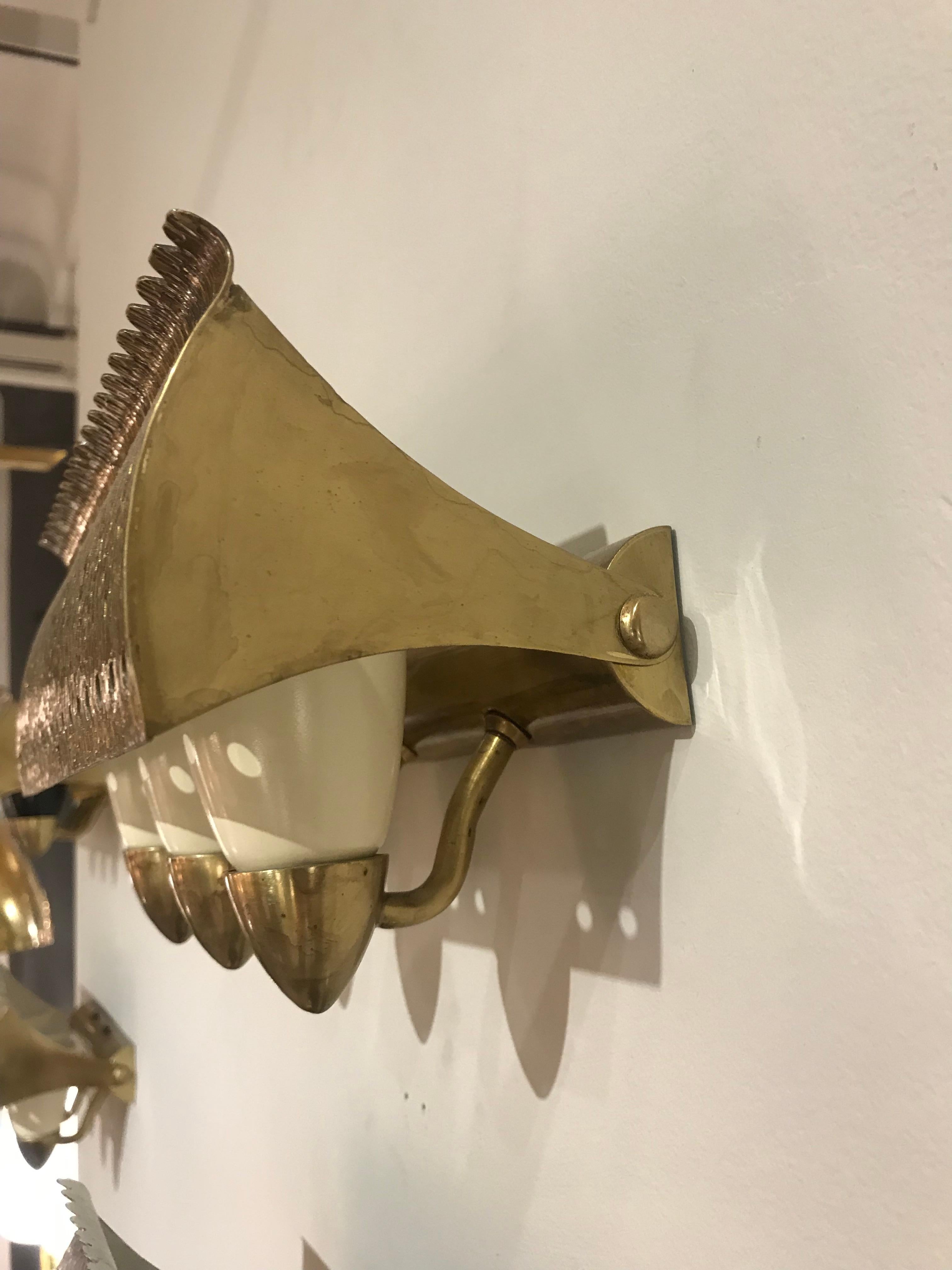 Brass structure holding three off-white cones, the shield is adjustable. A second pair is available.
Our # N-10030b.