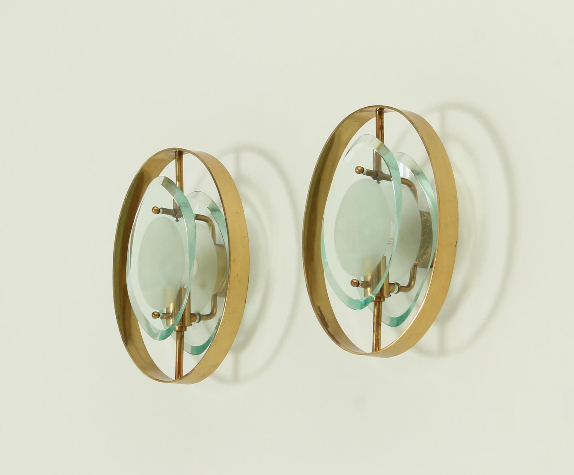 Pair of sconces model 2240 designed in 1961 by Max Ingrand for Fontana Arte, Italy. Double grind-molded glass with opaque excavation in matt glass and brass frame.