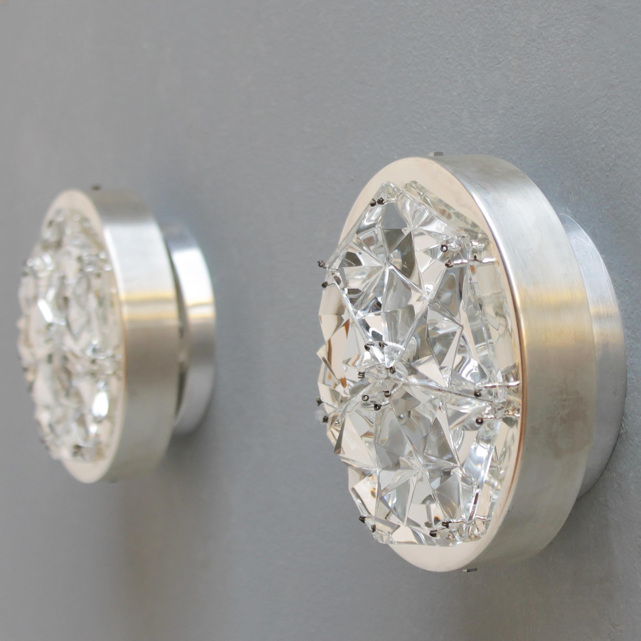 A pair of nickel-plated Kinkeldey sconces with triangular crystals.
Dimensions: height 2.8 in. (7 cm), diameter 6.7 inches (17 cm).

Kinkeldey is a German manufacturer of high end lighting fixtures. The company attracted international attention