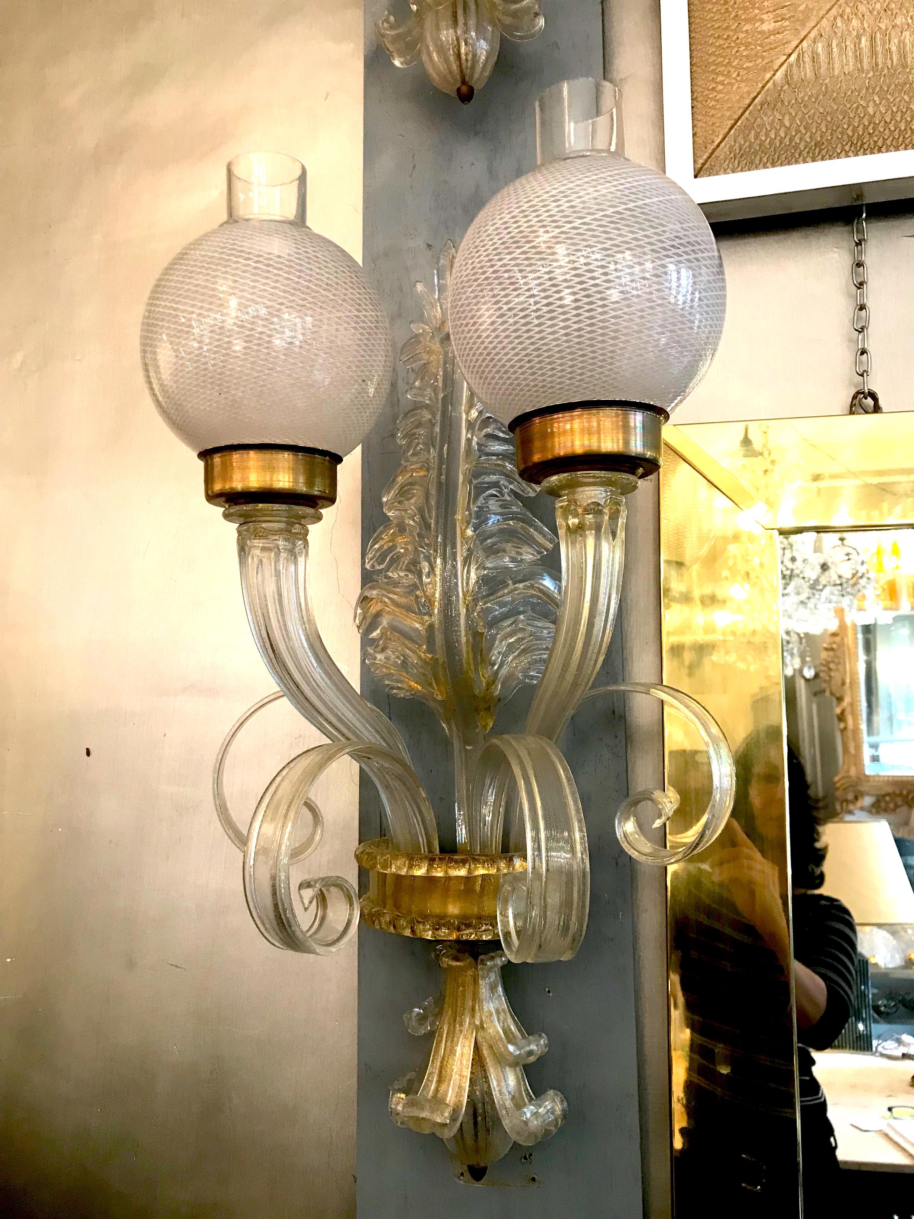 Fabulous pair of wall lights with a precious Murano glass Reticello balls.

Provenance from a historic luxurious Italian hotel.