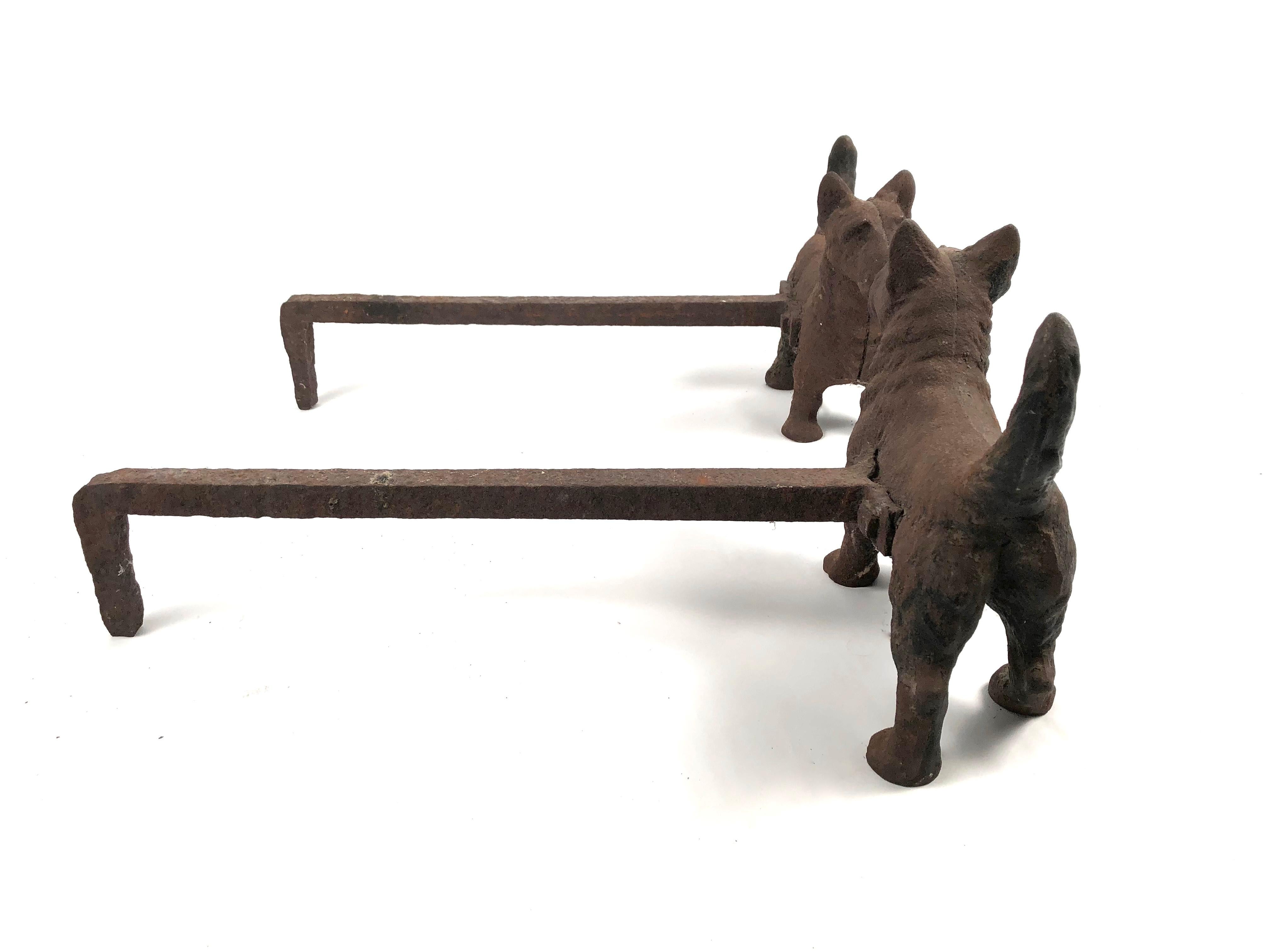 A pair of figural Scottie (Scotch Terrier) dog andirons, circa 1920s, in cast iron with traces of old black paint. Each dog is modeled in three dimensions, versus simply in profile, with an alert stance. Very solid and perfect for dog lovers wanting